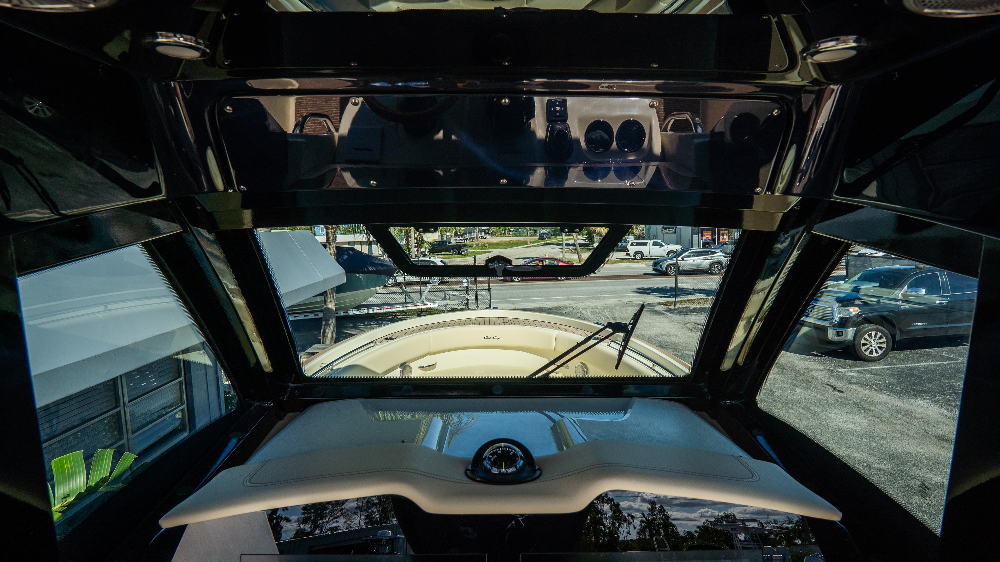 Interior view of 2025 Chris-Craft Catalina 30 boat cockpit with windshield and dashboard.