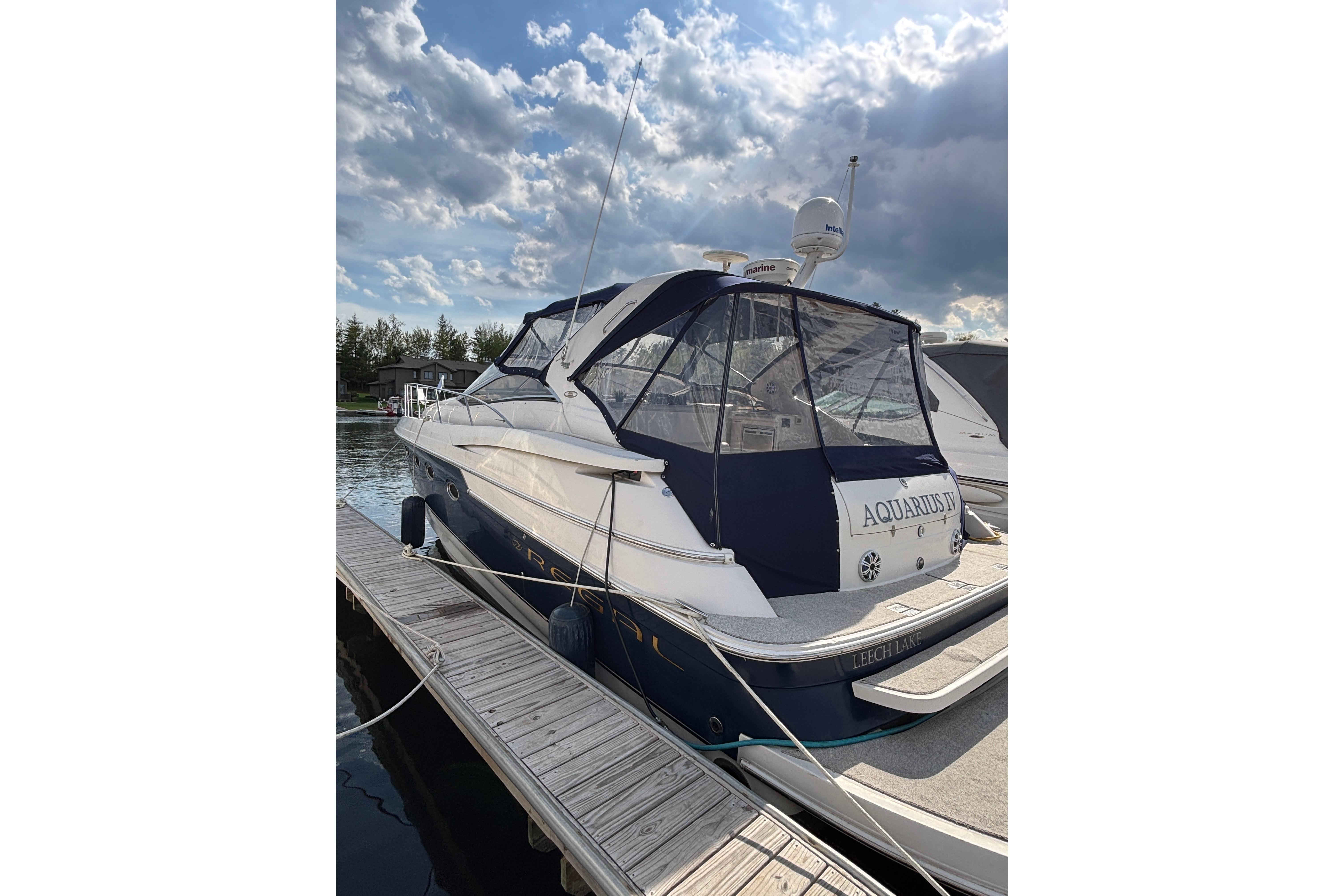 2000 Regal Commodore 4160 yacht docked under a partly cloudy sky.