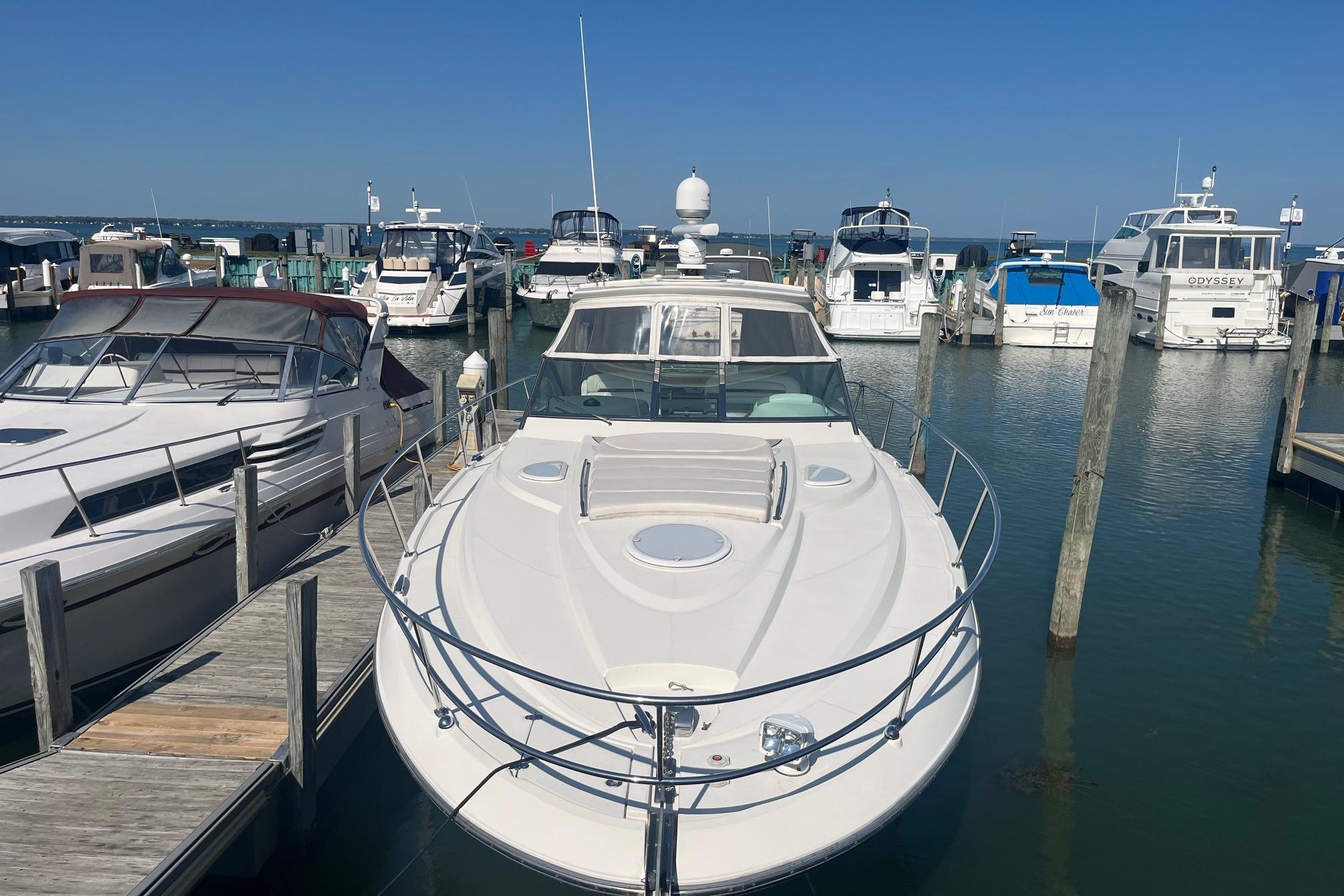 2010 Monterey 400 Sport Yacht docked at a marina under clear blue skies.