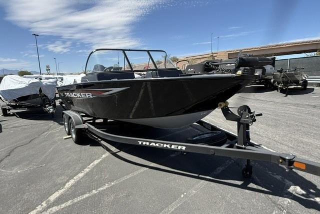 2025 Tracker Pro Guide V-175 WT boat on trailer in parking lot under clear sky.