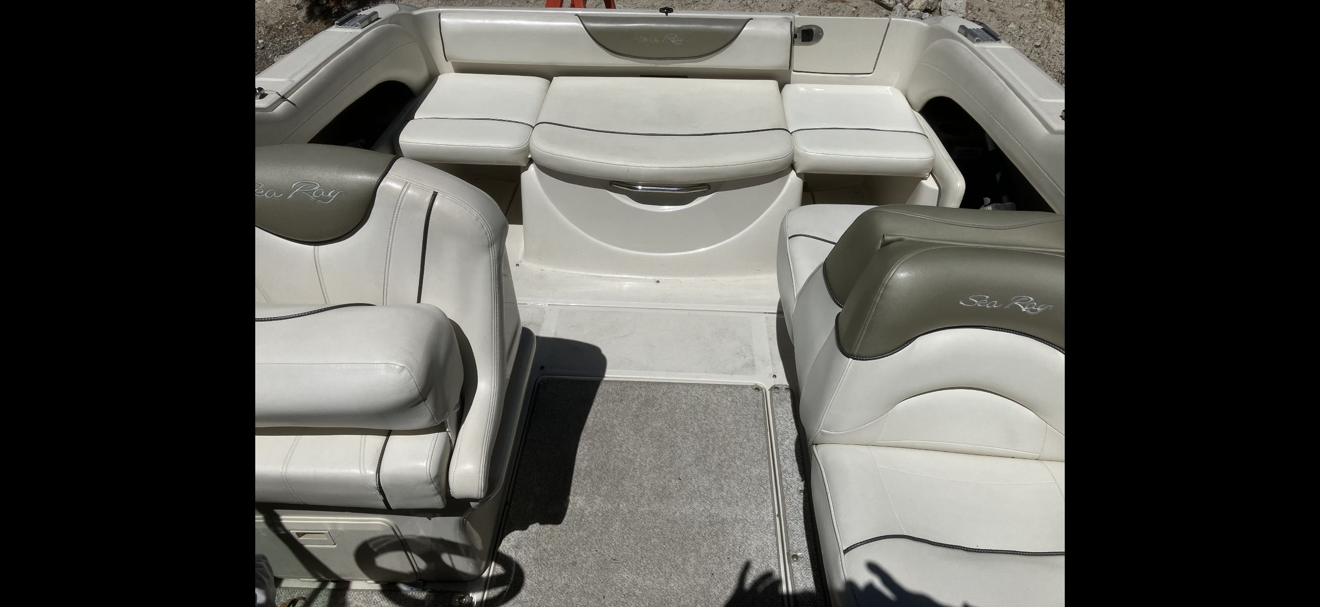 Interior of a 2007 Sea Ray 215 Weekender boat with white seating.