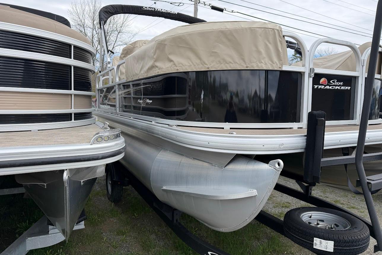 2025 Sun Tracker Party Barge 16 DLX pontoon boat, docked and covered.