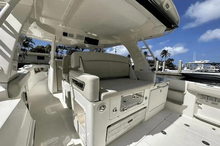 2019 Boston Whaler 350 Realm interior with seating, docked under clear blue sky.