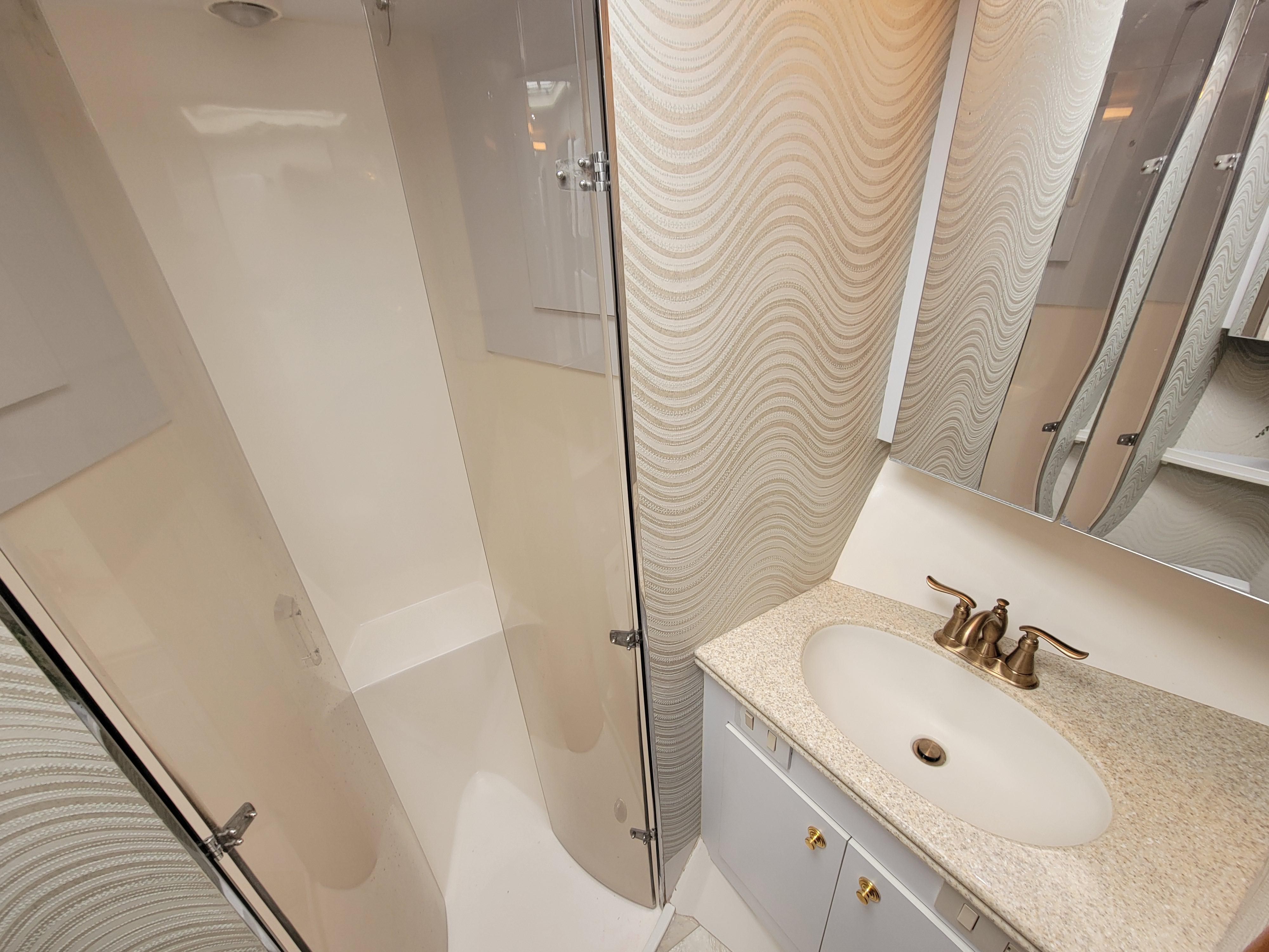 Bathroom interior of 2001 Ocean Yachts 56 Super Sport with shower and sink.