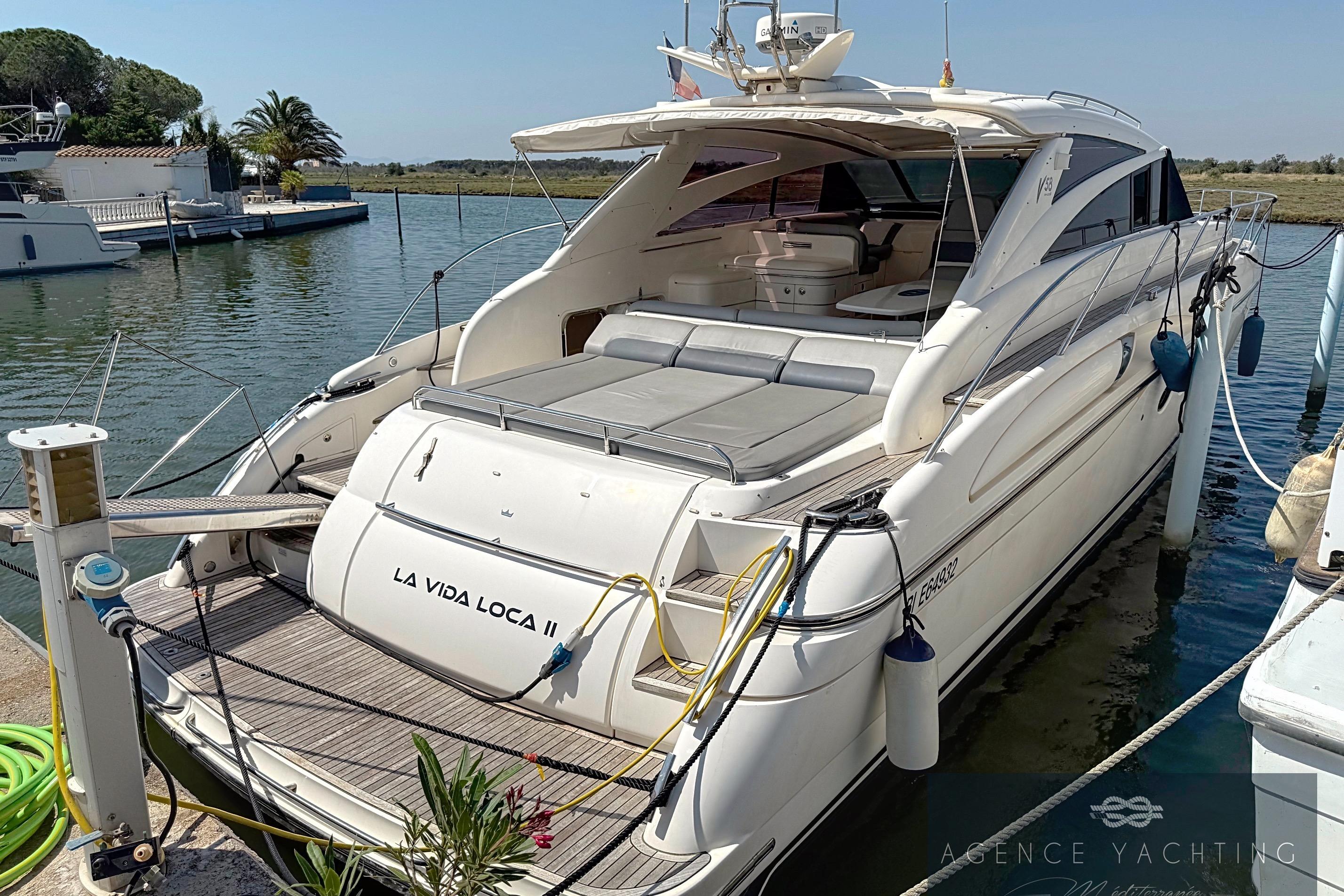 2004 Princess V58 yacht docked, featuring spacious deck and elegant design.