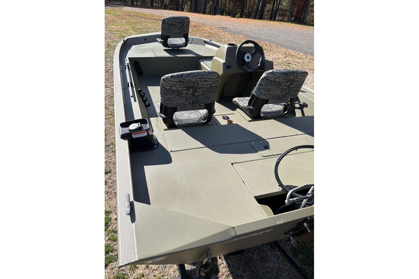 2026 Tracker Grizzly 1754 SC boat with camo seats and steering console.