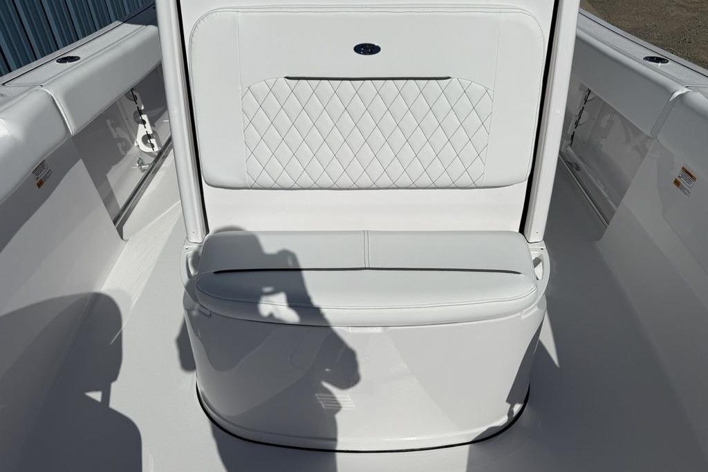 2026 Sportsman Open 232 Center Console boat interior with white cushioned seating.