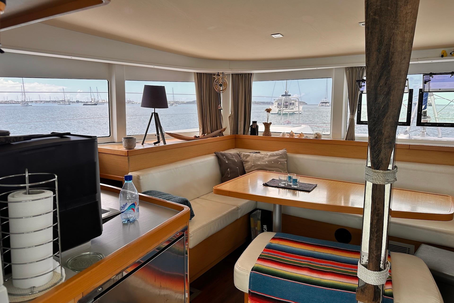 Interior of 2016 Lagoon 42 catamaran with cozy seating and ocean view.