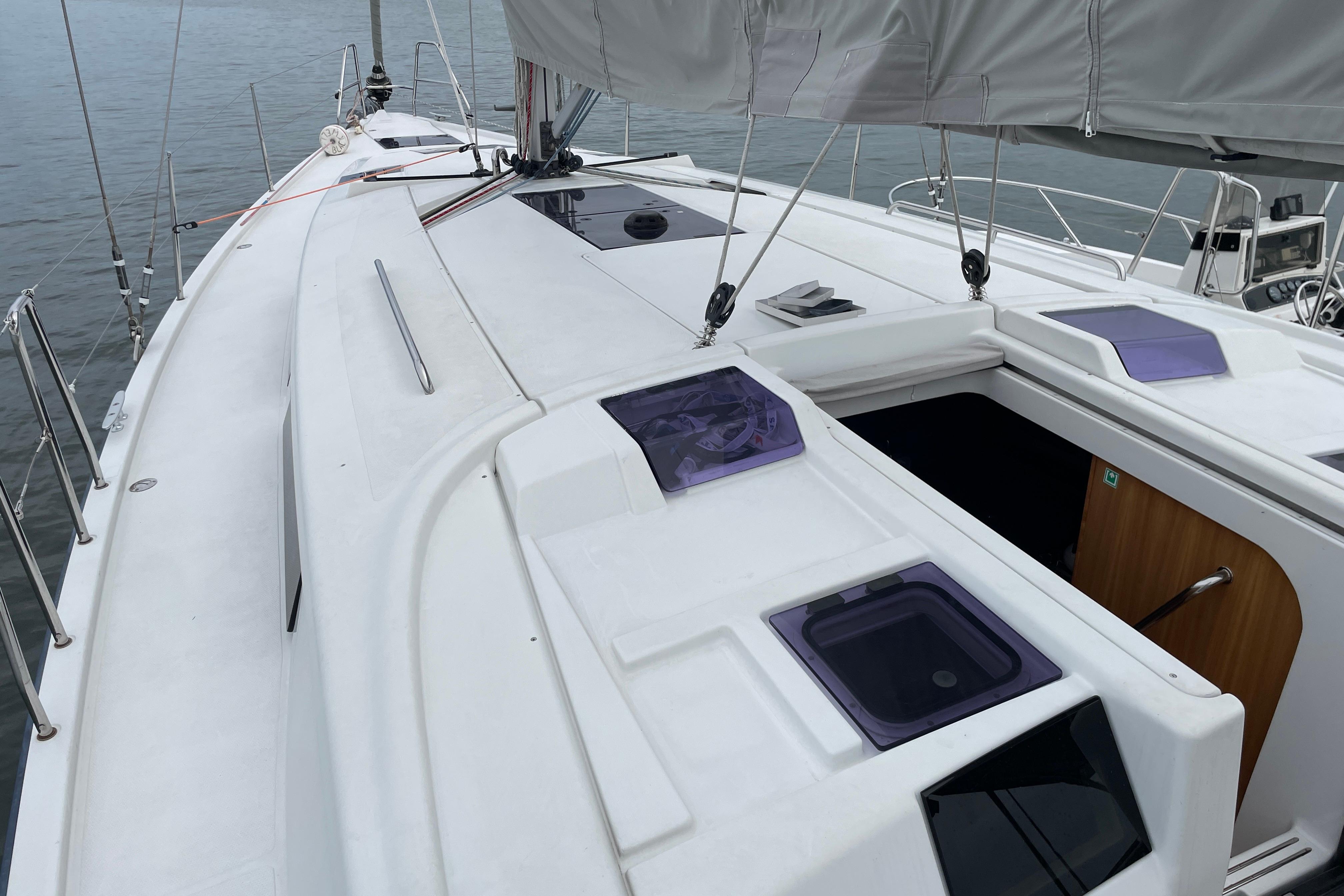 2014 Hanse 415 sailboat deck with open hatch, sleek design, and visible rigging.
