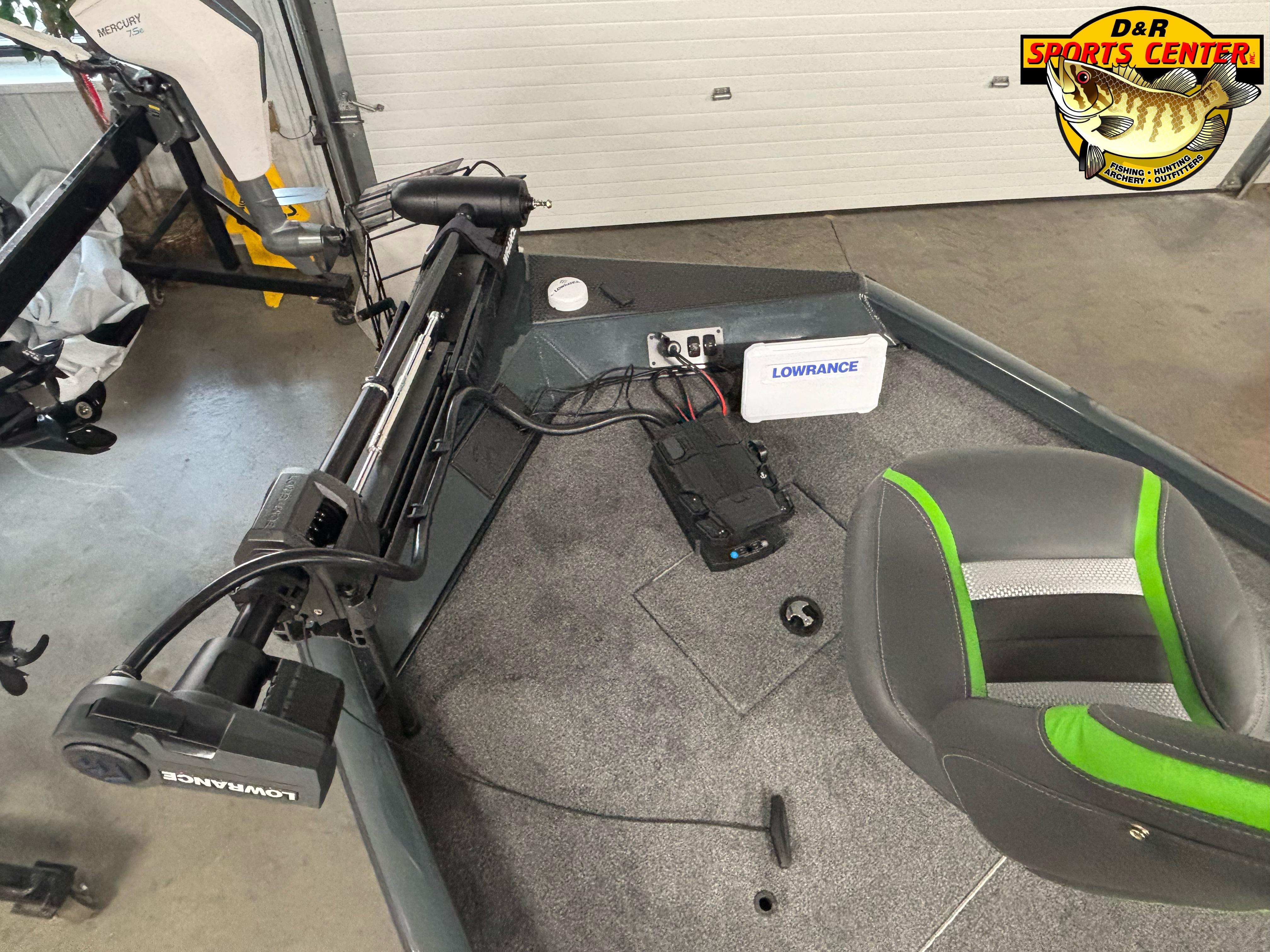 2025 Ranger RT188C boat interior with Lowrance equipment and Mercury motor in a showroom.