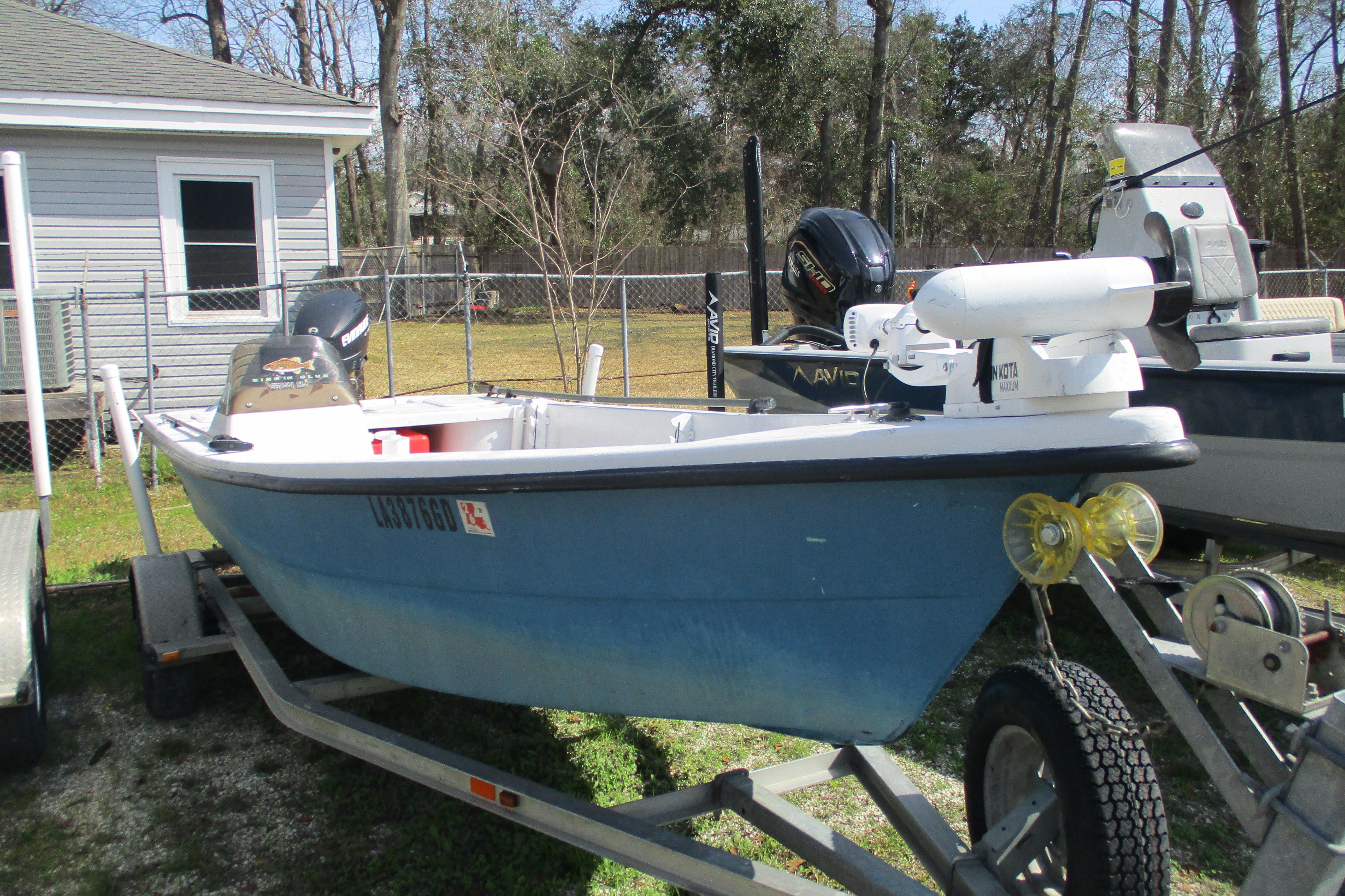 2012 Stumpknocker 17 SPORT boat on trailer, parked outdoors near a house.