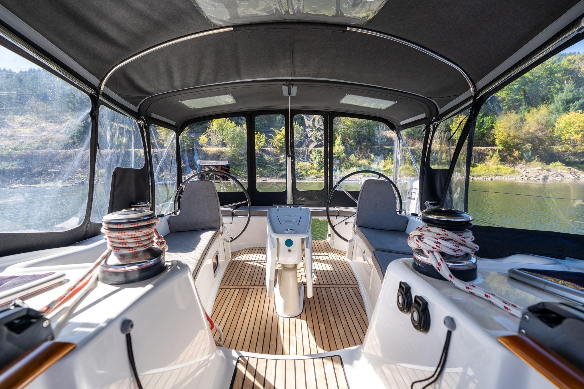 Interior view of 2013 Beneteau Oceanis 50 sailboat cockpit with dual steering wheels.