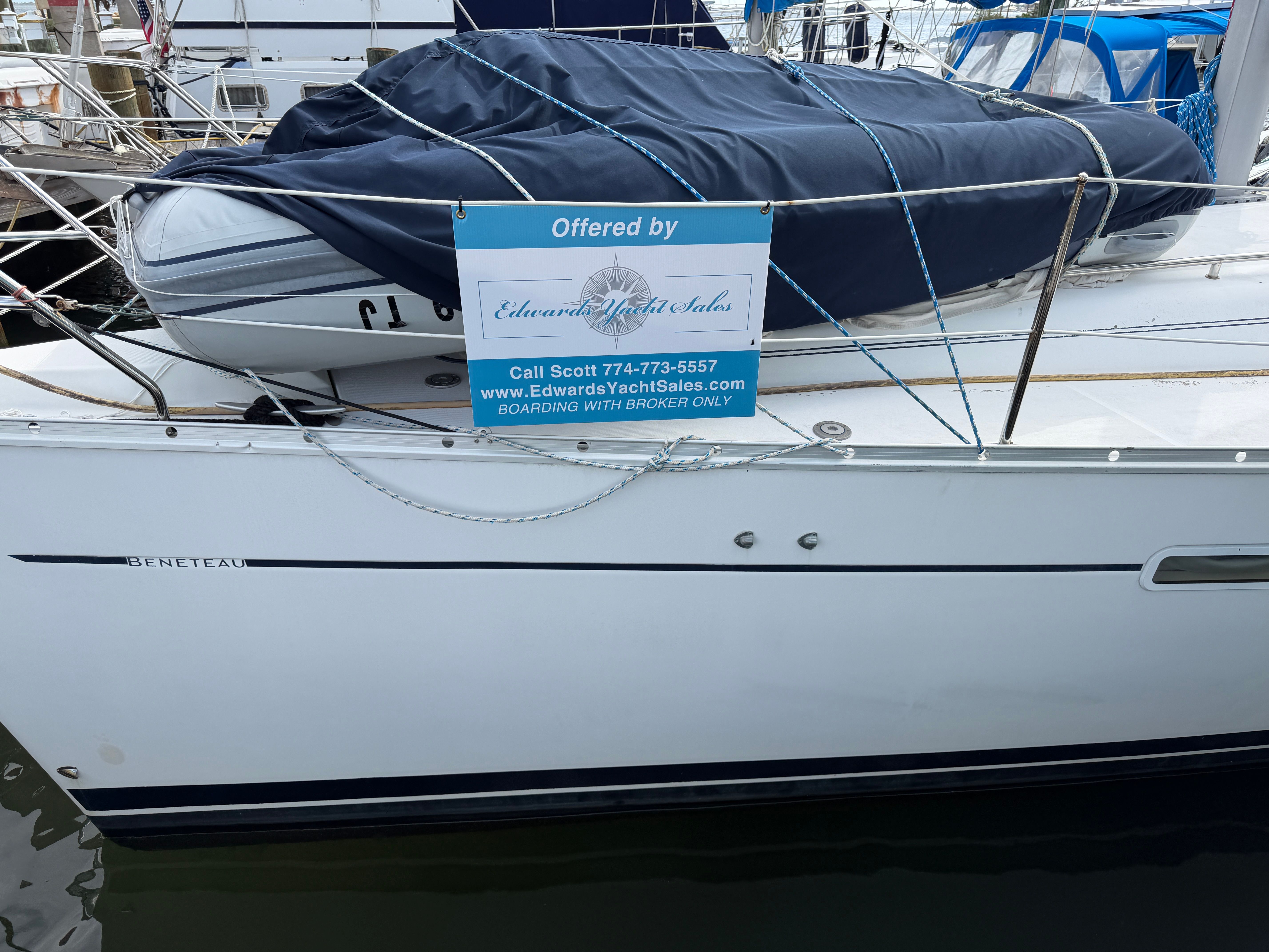 Beneteau sailboat with sales sign at dock, 1988 Regal Commodore 360.