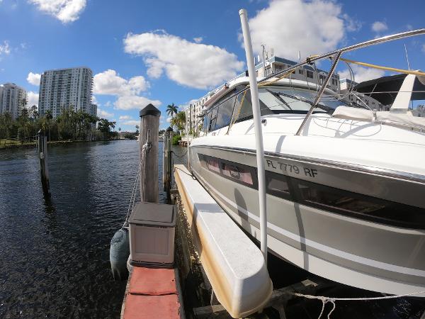 2017 Jeanneau NC 11 docked at a marina with high-rise buildings in the background.