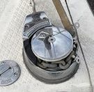 Close-up of a winch on a sailboat deck.