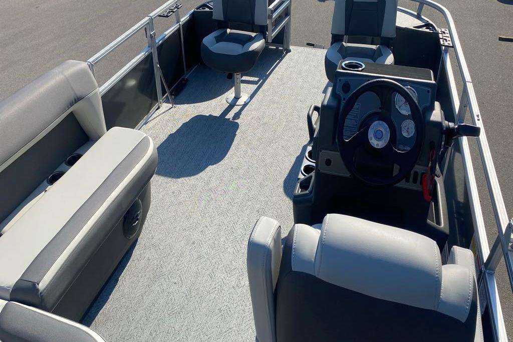 2026 Sun Tracker Bass Buggy 18 DLX pontoon boat interior with seating and steering console.