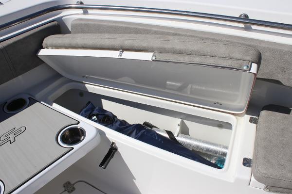 2023 Sea Pro 239 Center Console boat storage compartment with open lid and seating area.