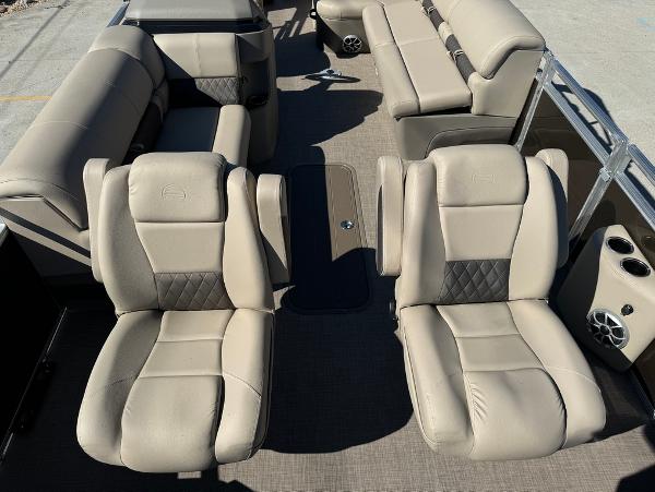 2025 Sun Tracker 24 Sportfish XP3 interior with beige seating and modern design.