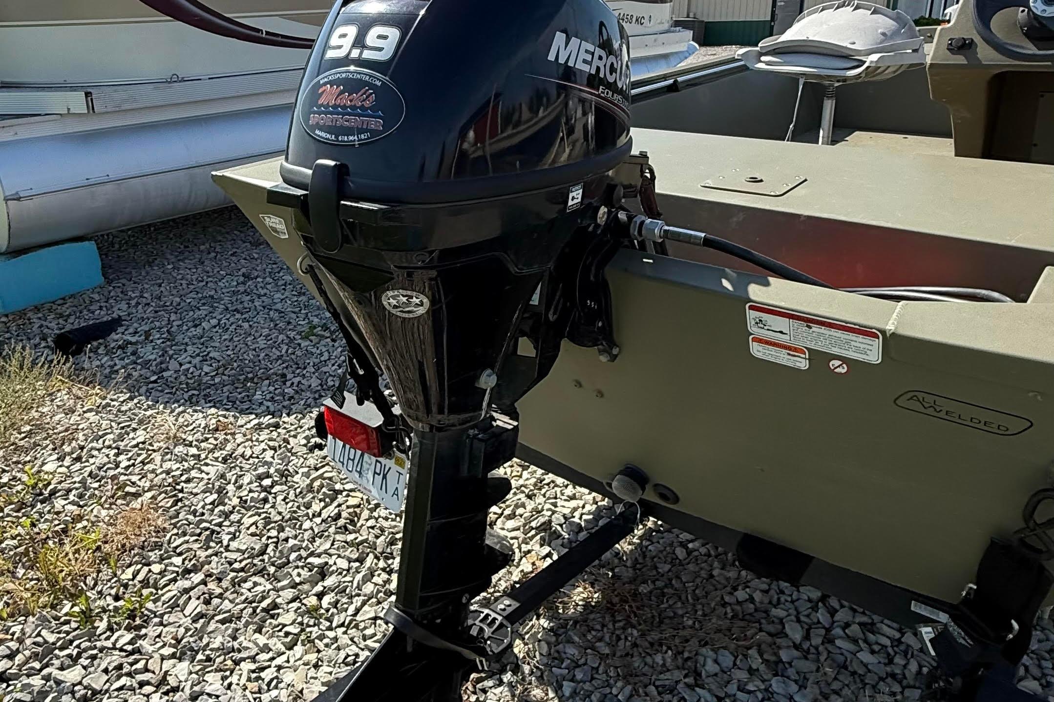 2019 Tracker Grizzly 1648 SC boat with Mercury 9.9 outboard motor on gravel.
