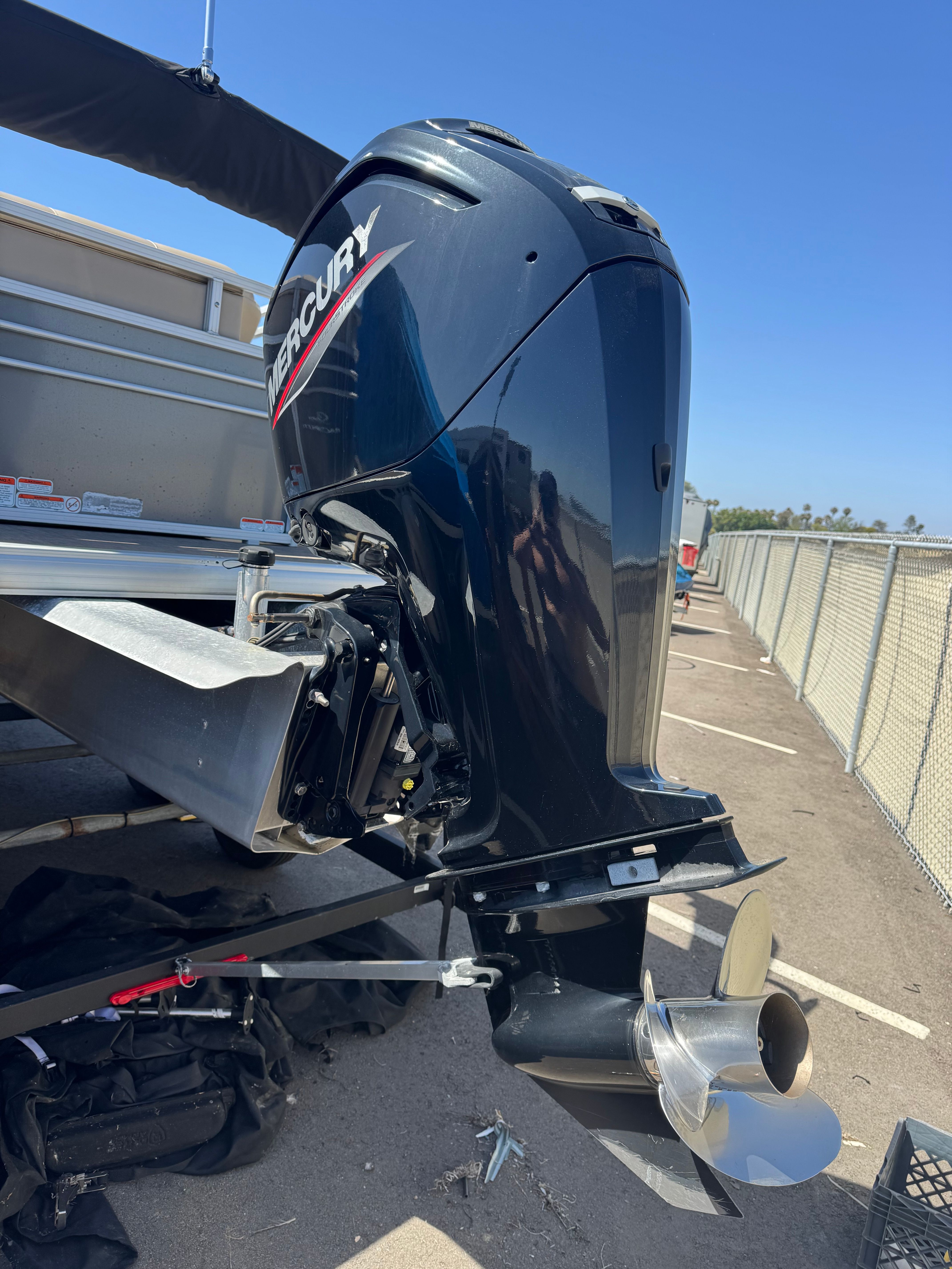 A Mercury outboard motor is mounted on a Sun Tracker Party Barge 20 DLX boat.
