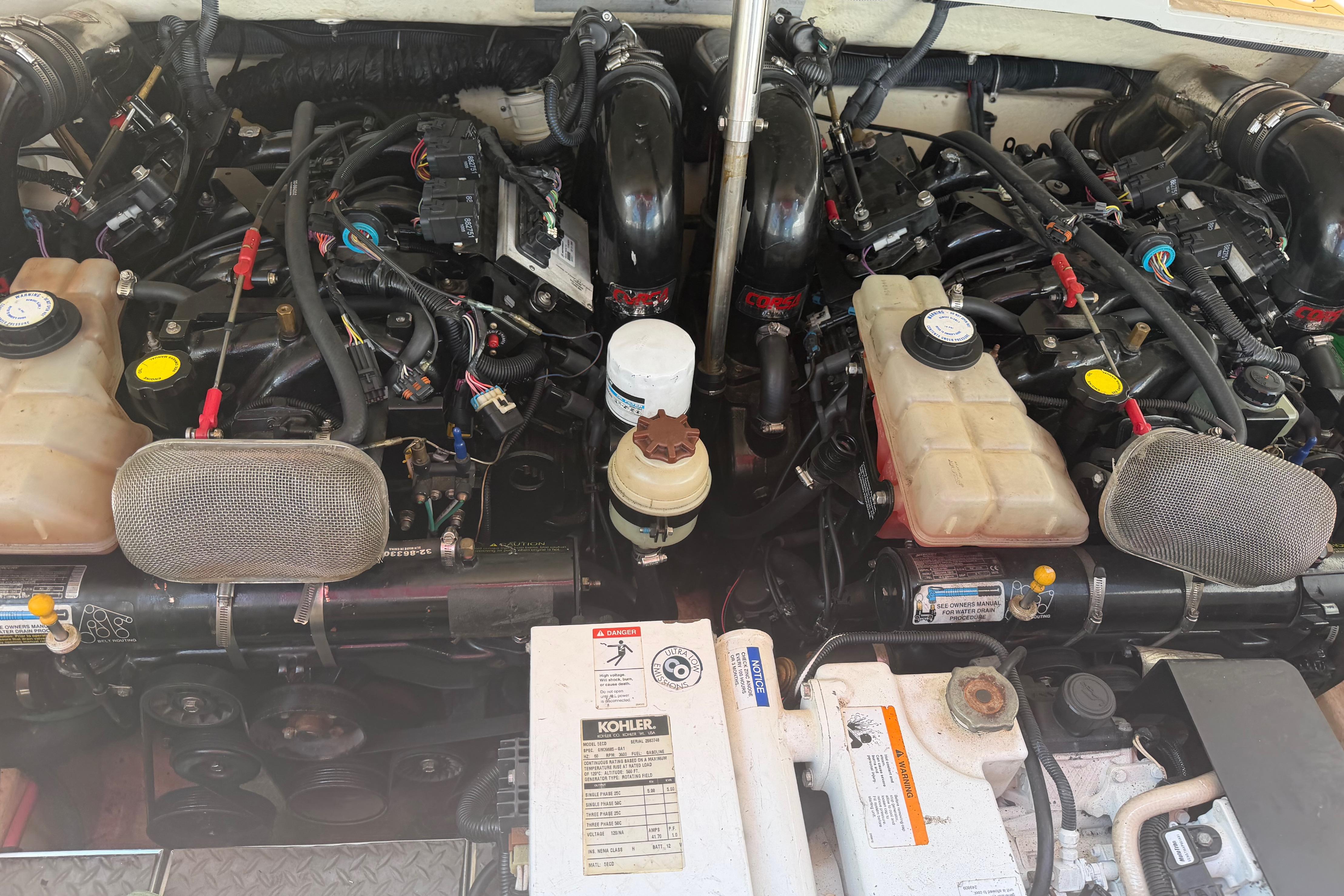 Engine compartment of a 2006 Formula 330 Sun Sport boat, showcasing dual engines and components.