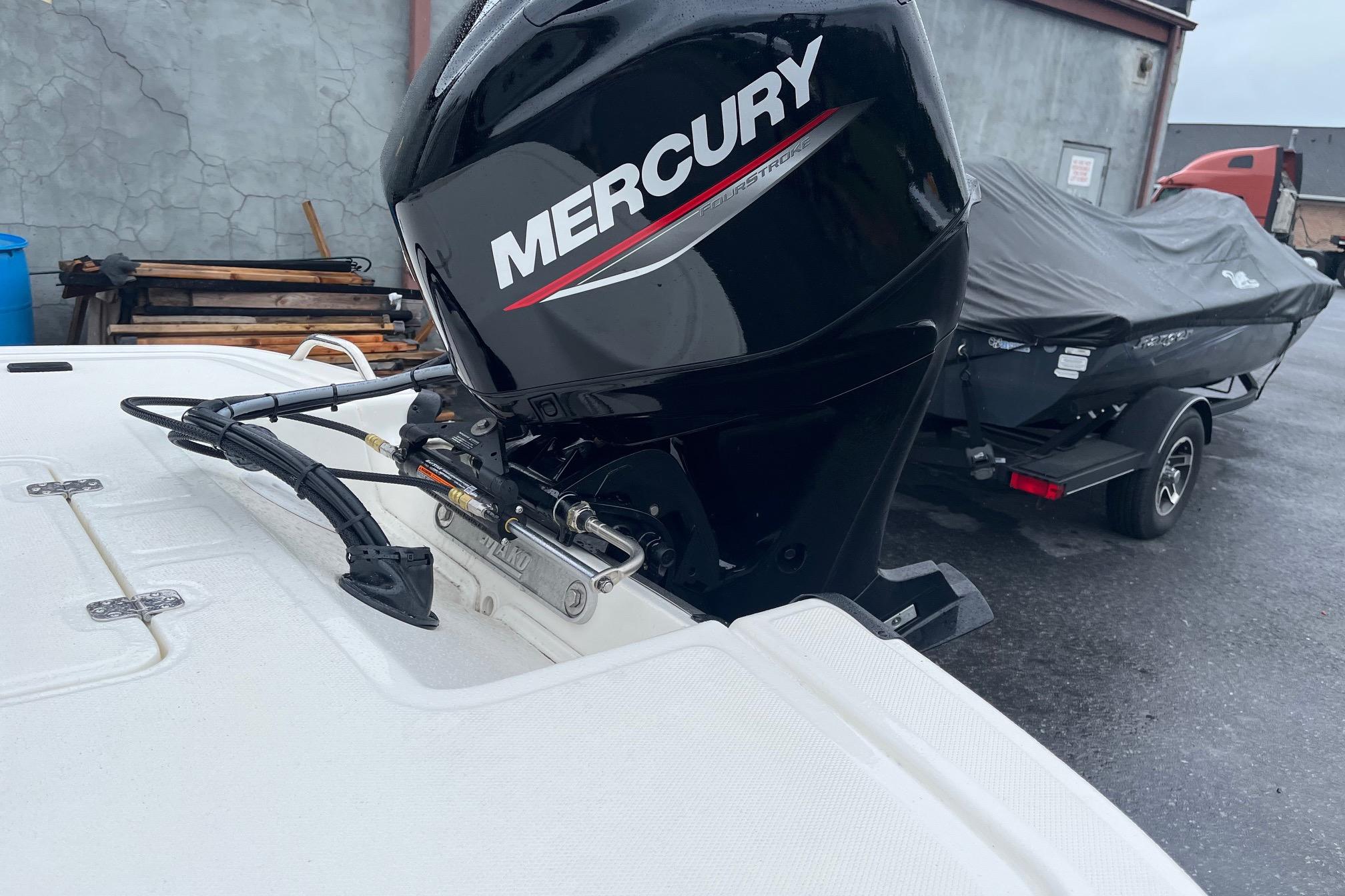 2026 Mako Pro Skiff 17 CC with Mercury outboard motor in a parking area.