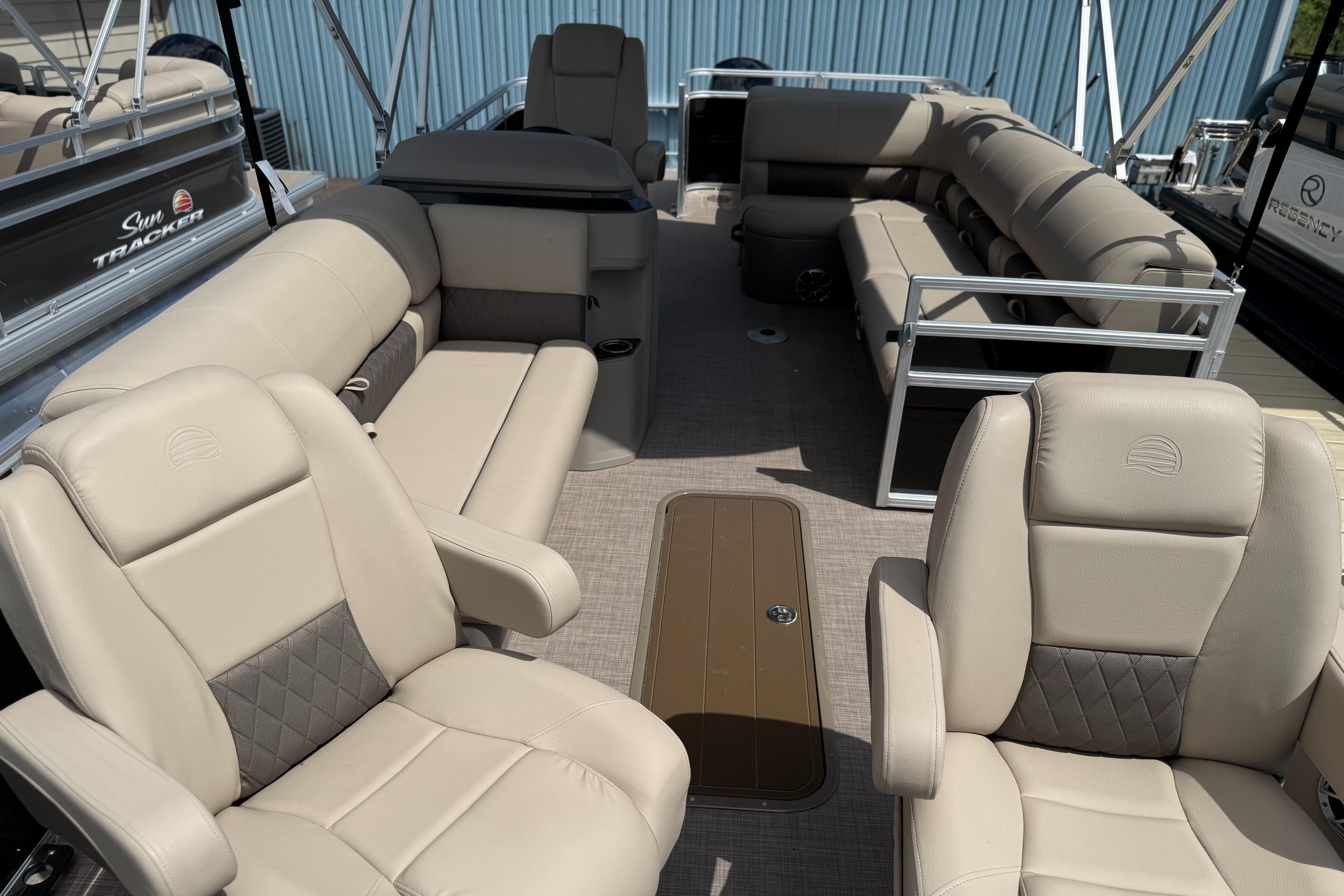 2024 Sun Tracker Sportfish 24 XP3 pontoon boat interior with beige seating and spacious layout.
