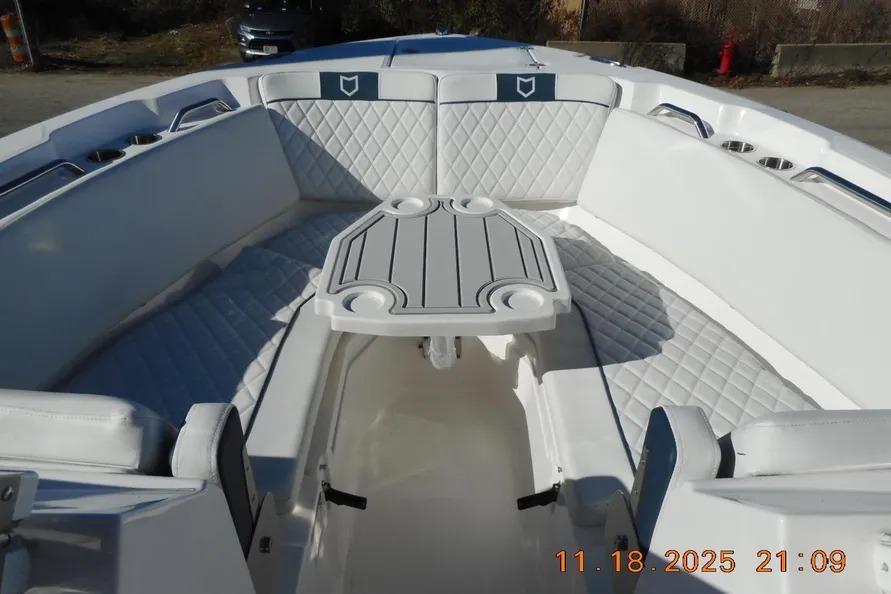 Interior view of 2026 Sea Fox 268 Traveler boat with cushioned seating and table.