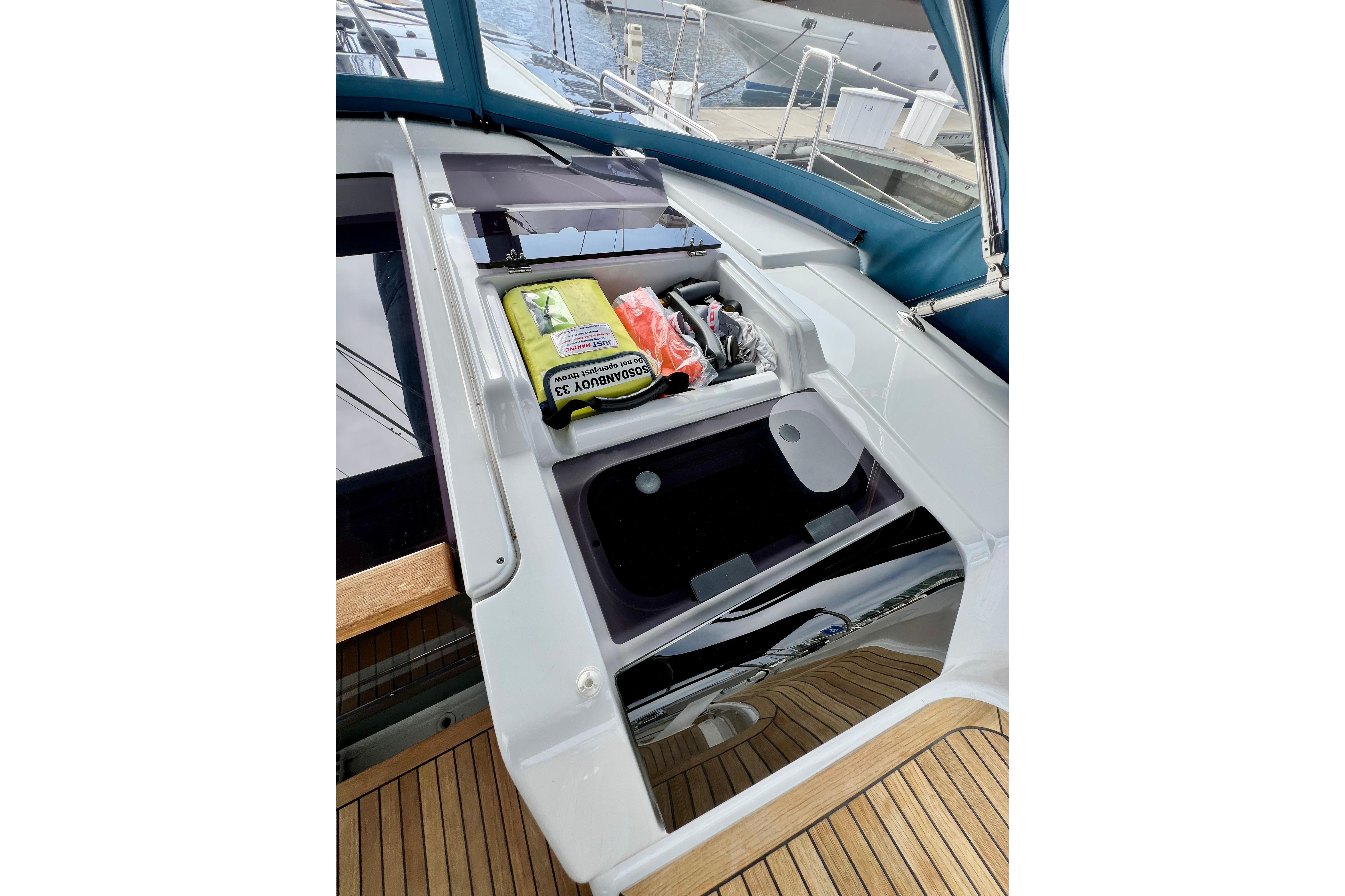 Storage compartment on 2016 Hanse 455 yacht with safety equipment and supplies.