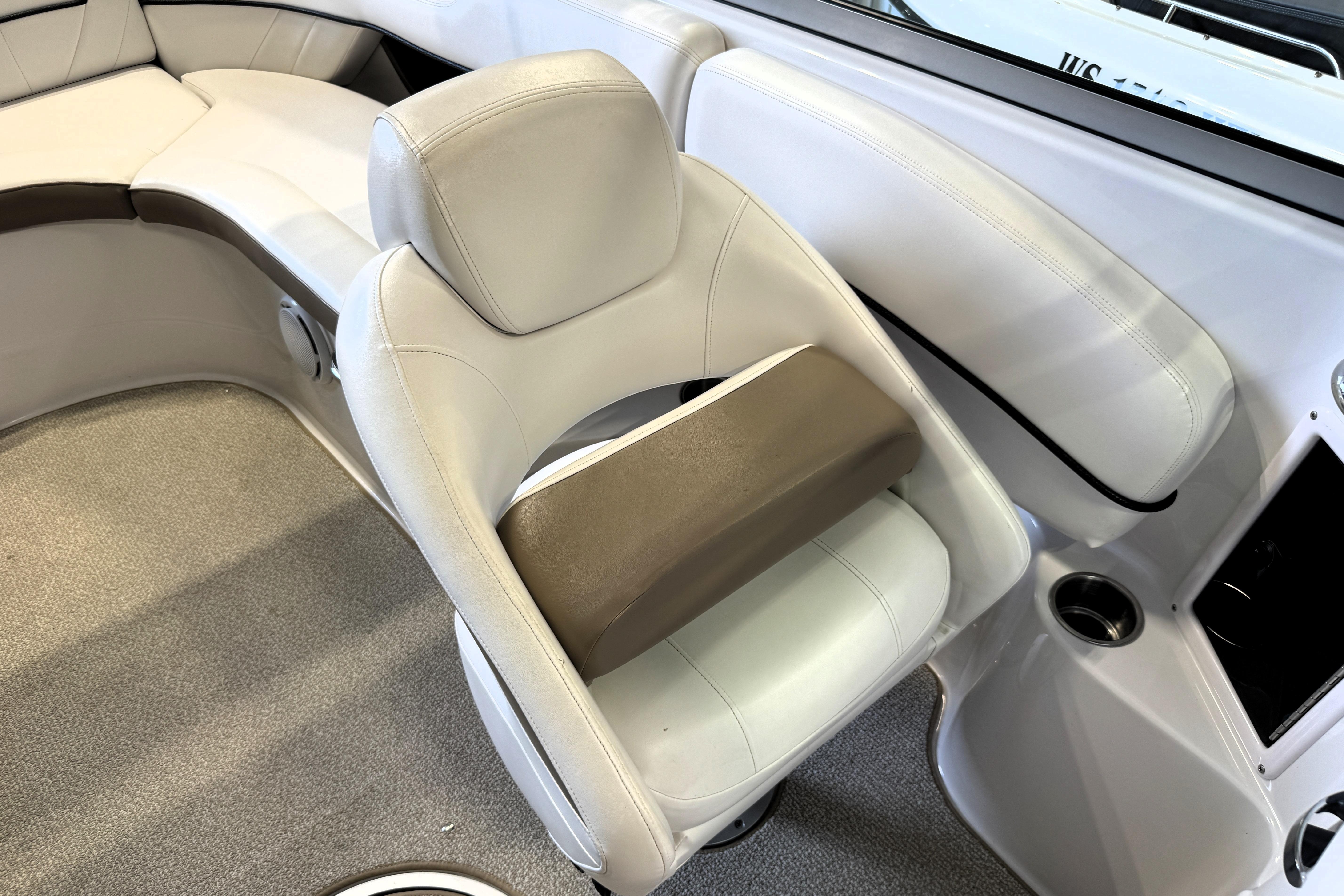 2008 Four Winns H240 boat interior with white leather seating and cup holder.
