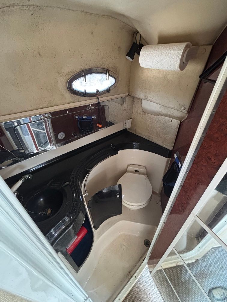 Interior of a 1997 Donzi 275LXC with toilet and sink.