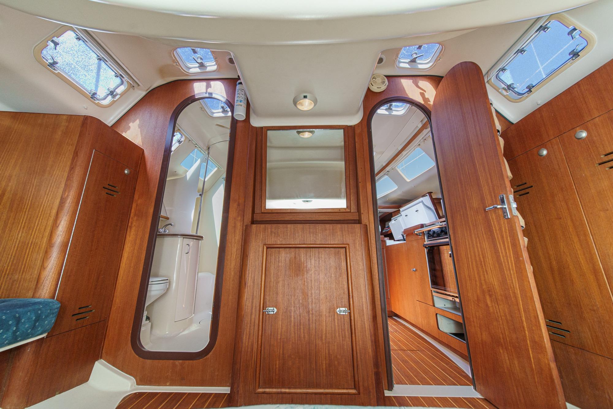Interior of a 1996 Hunter 376 sailboat with wooden cabinetry and natural light.