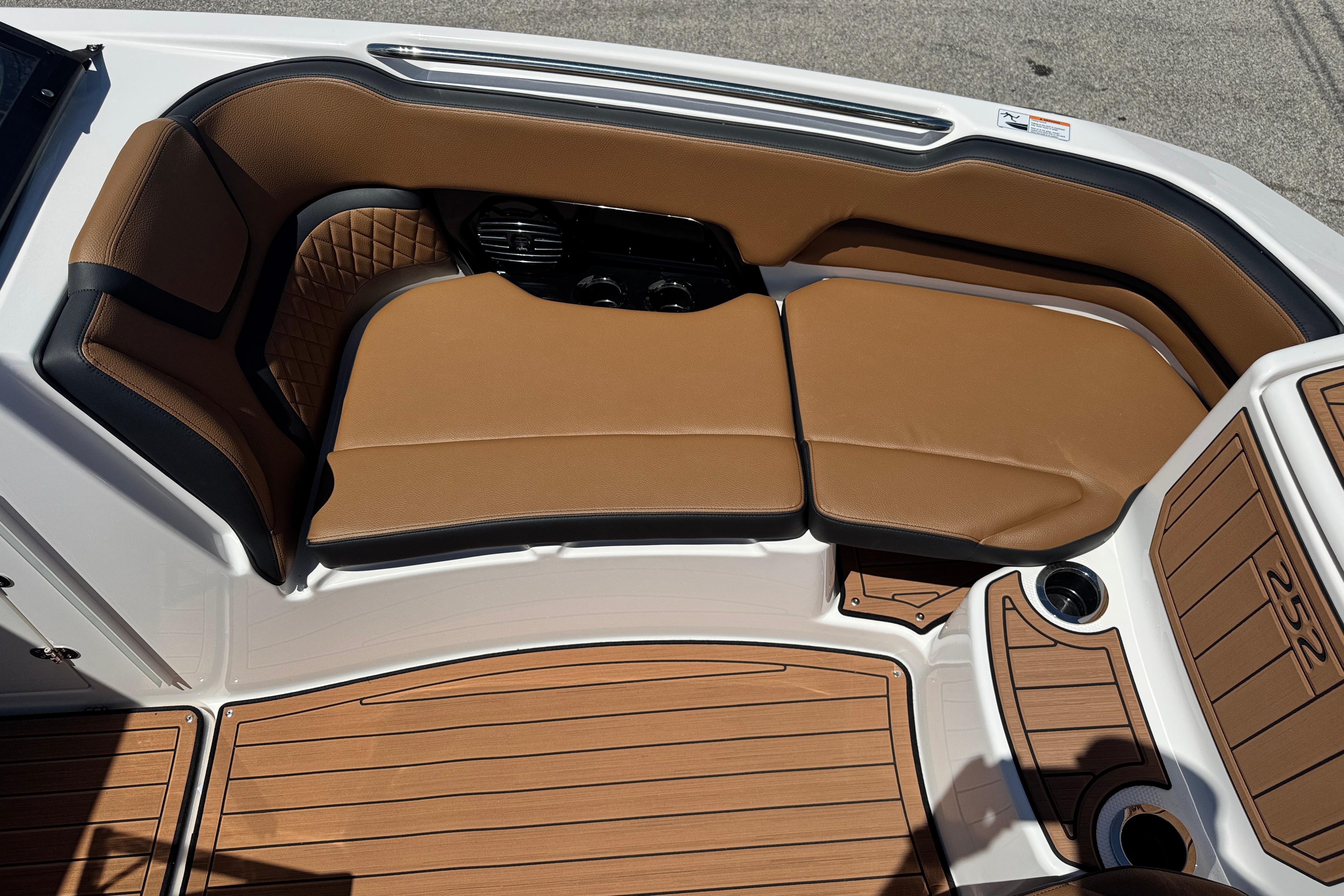 2026 Yamaha Boats 252SD interior with tan seating and wood-style flooring.