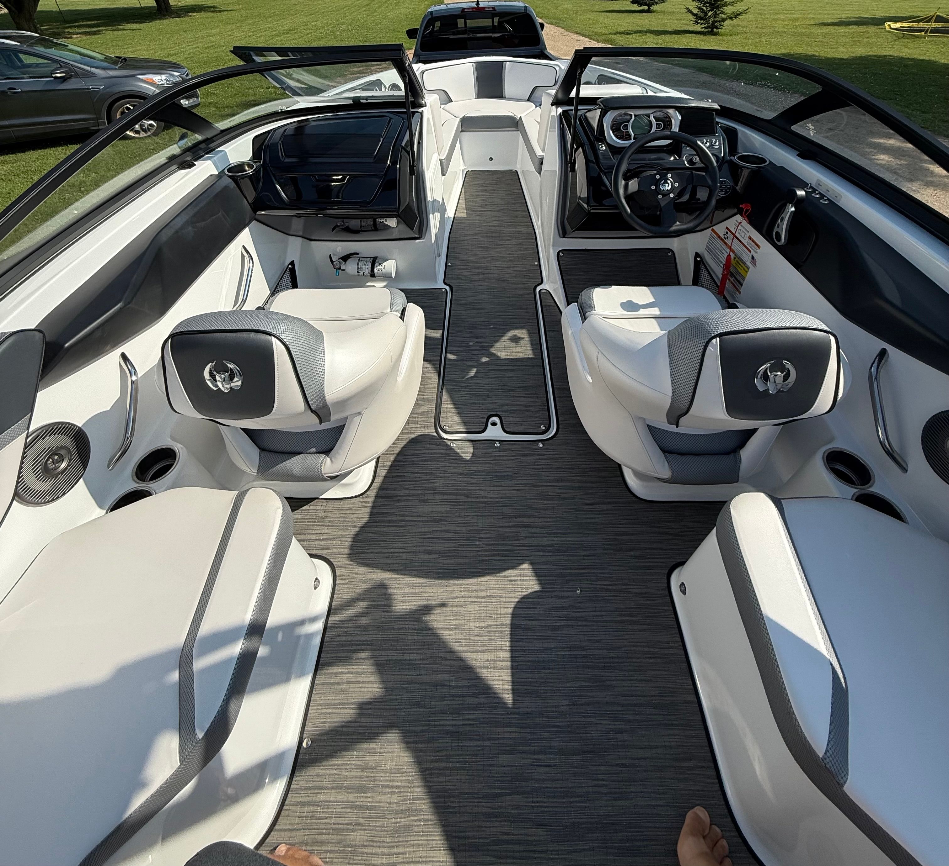 Interior view of a modern Scarab 195 ID boat with stylish seating and a sleek dashboard.