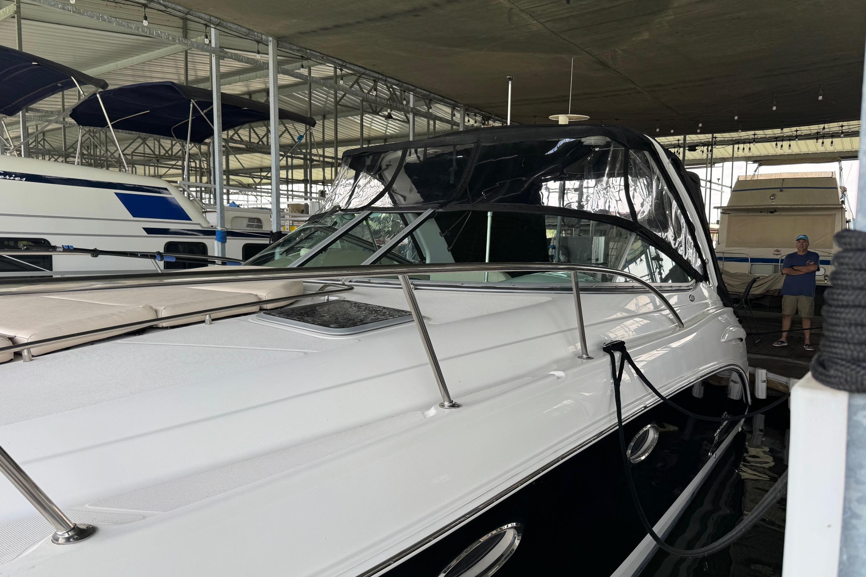 2006 Chaparral 330 Signature boat docked in a covered marina.