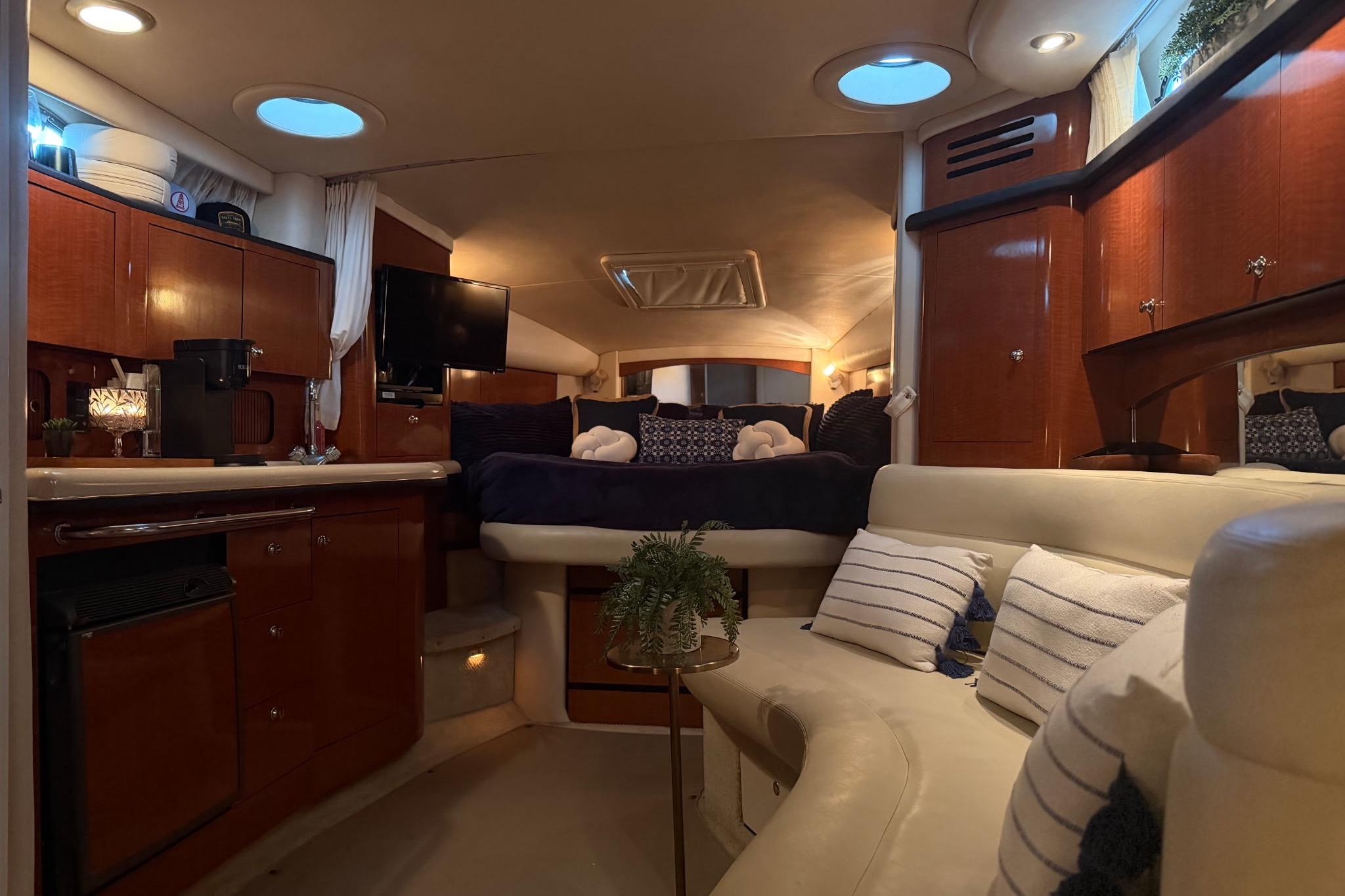 Luxurious interior of a 2002 Sea Ray Sundancer 320 yacht with cozy seating and elegant decor.