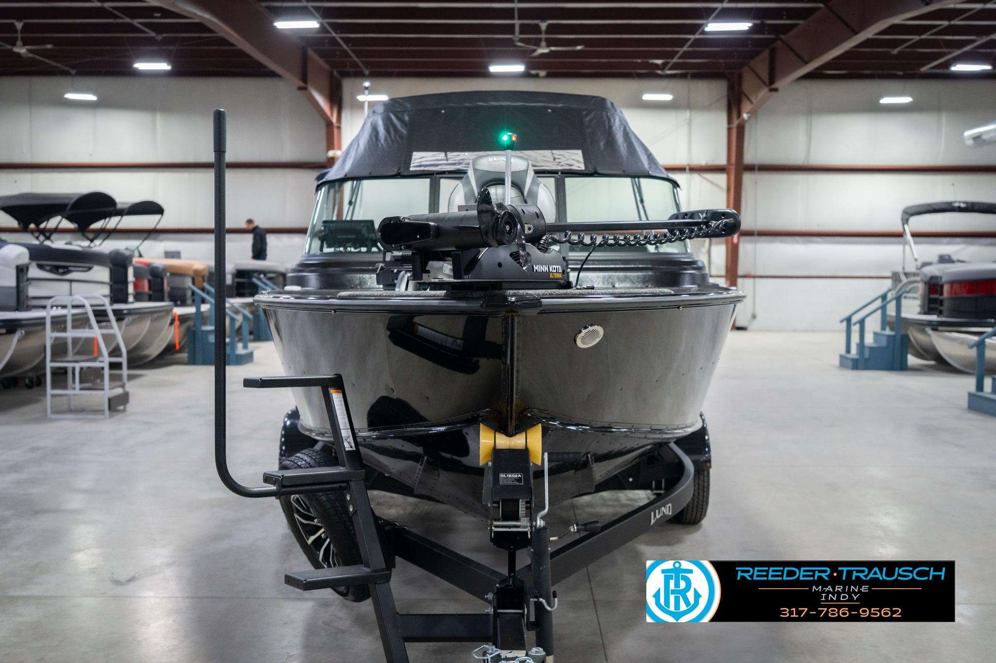 2026 Lund 2075 Impact XS boat in showroom, front view with trailer.