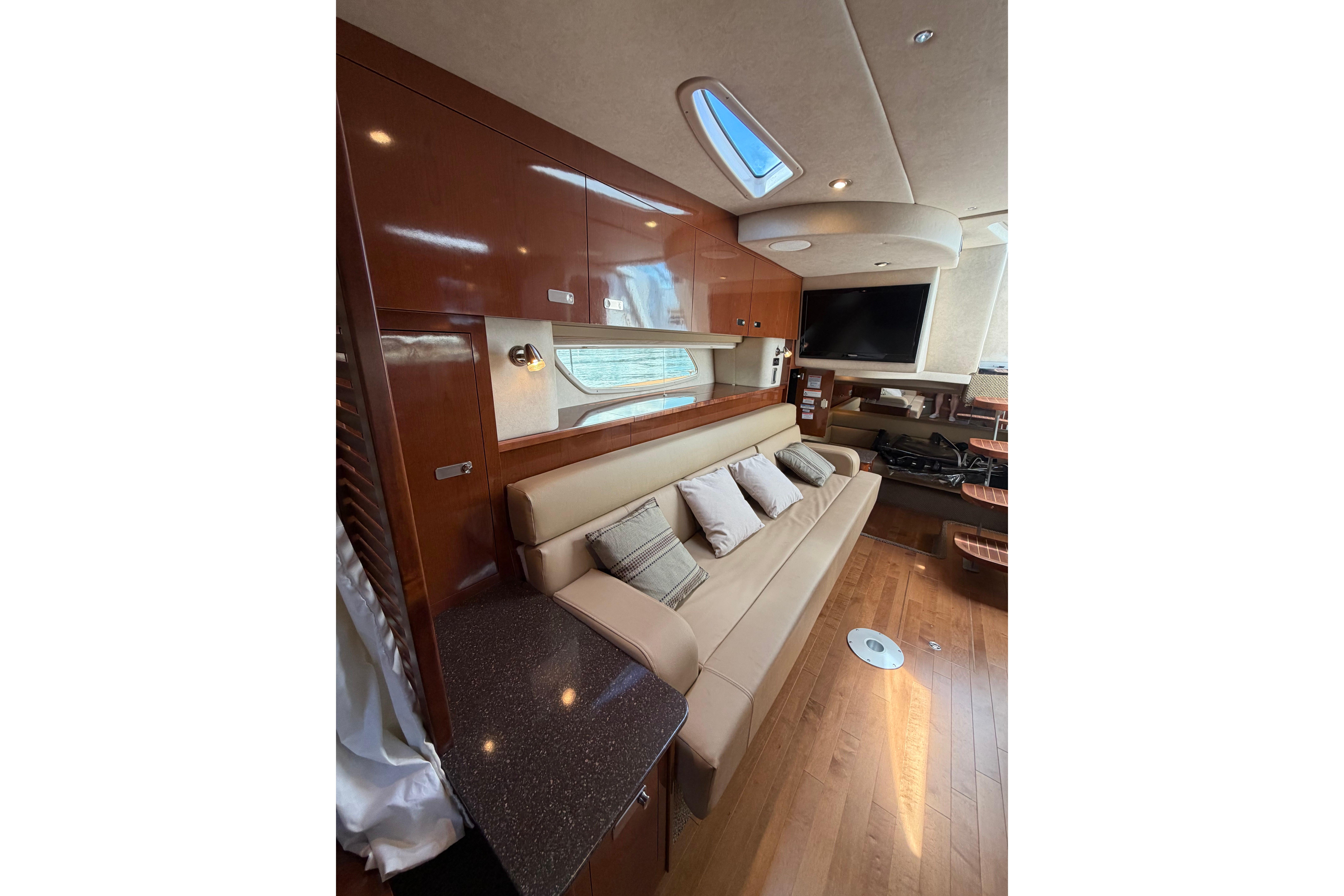 Luxurious interior of 2012 Sea Ray Sundancer 370 yacht with plush seating and modern amenities.