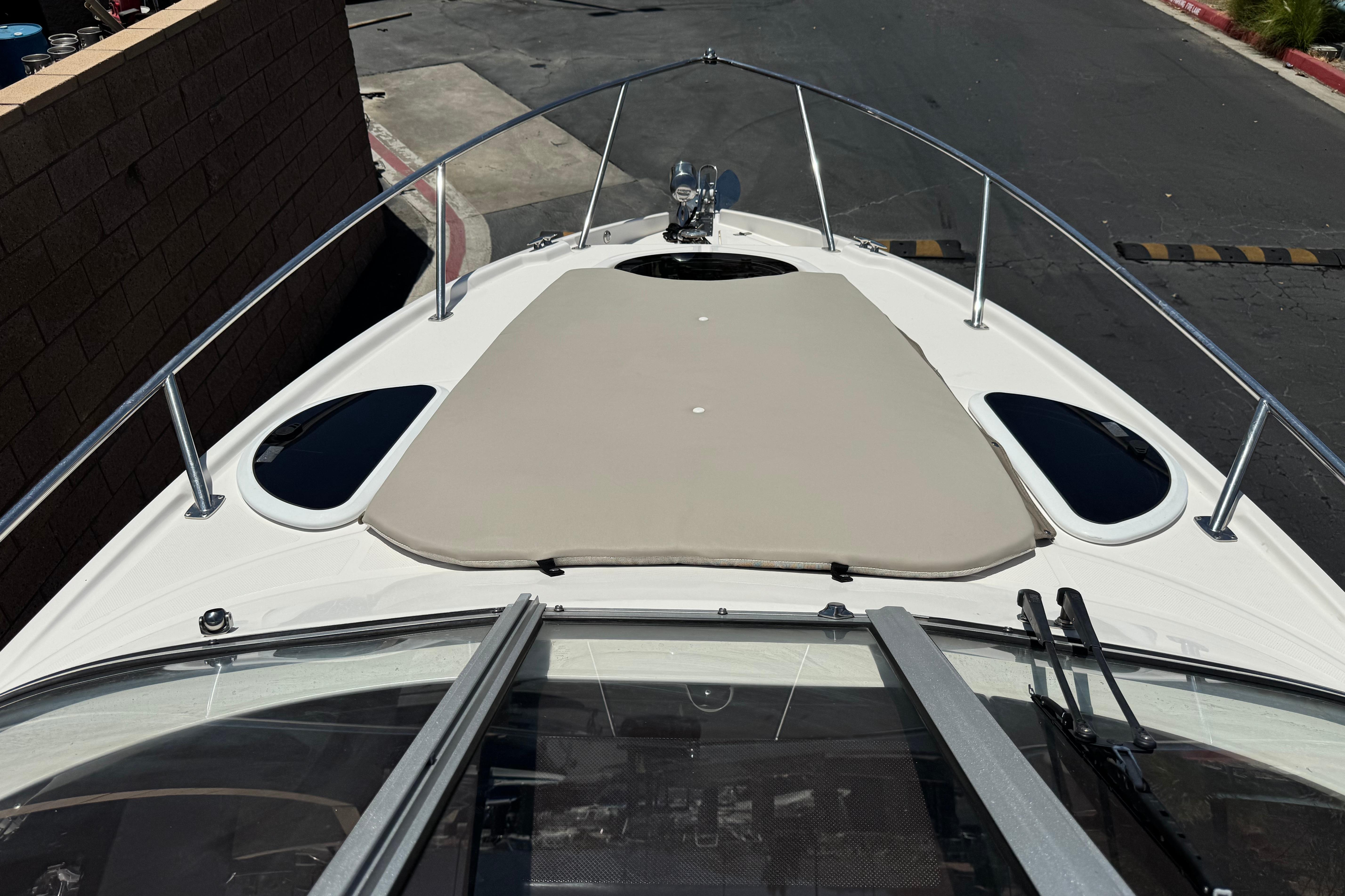 2013 Regal 28 Express boat bow with sunpad and stainless steel railings.