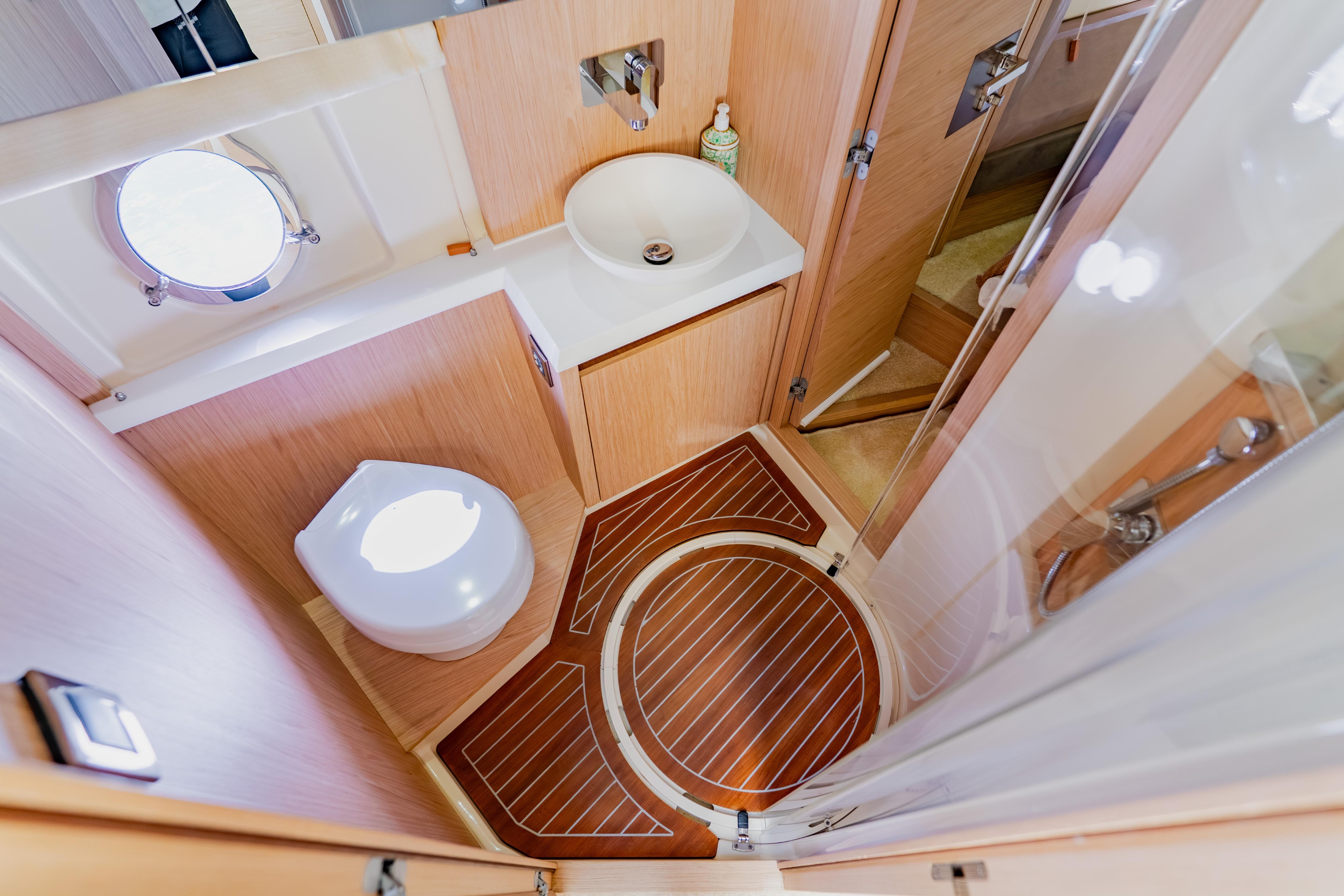 Luxurious 2015 Monte Carlo MC5 yacht bathroom with modern fixtures and wooden flooring.