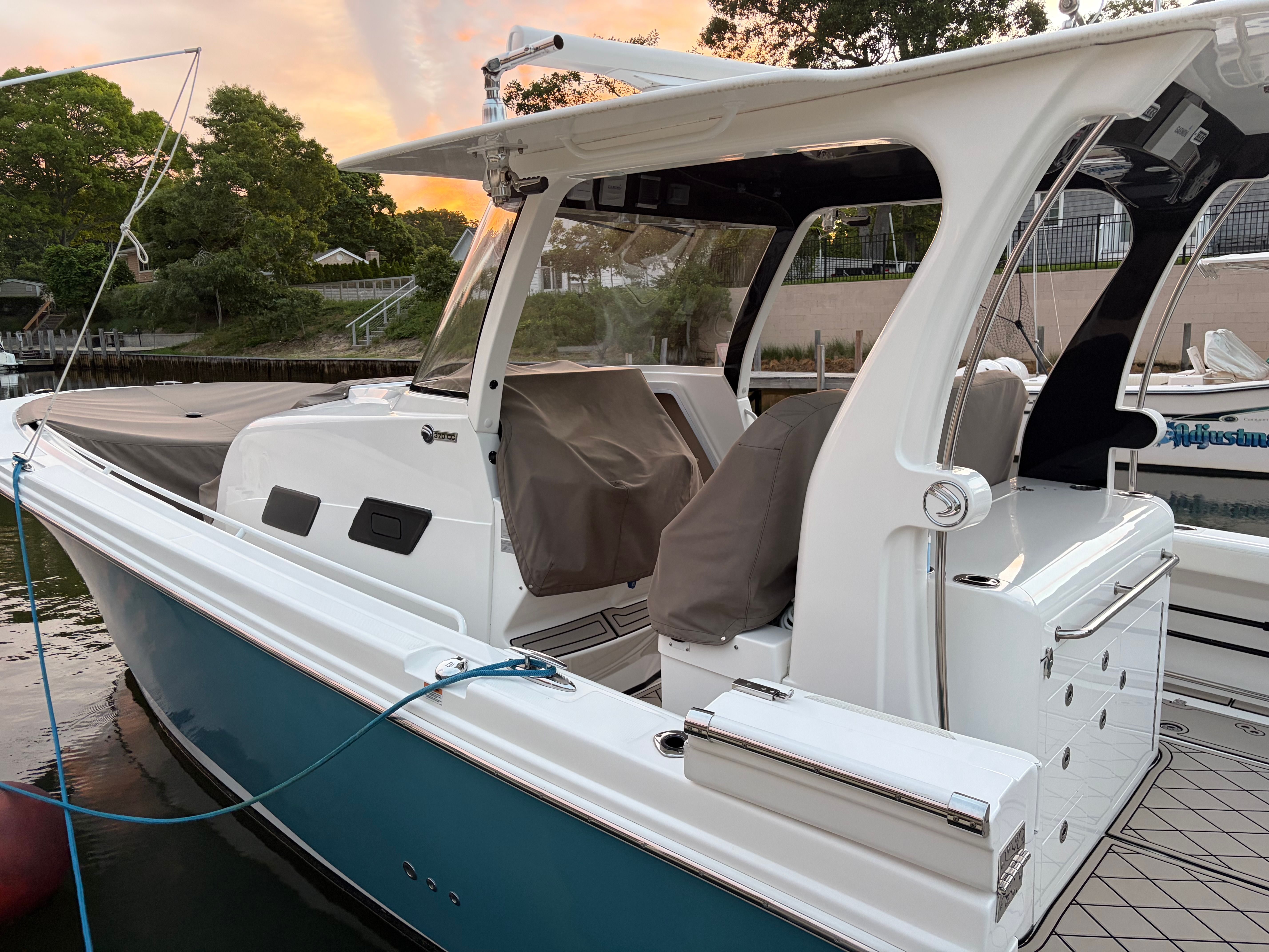 2019 Edgewater 370CC boat docked at sunset.