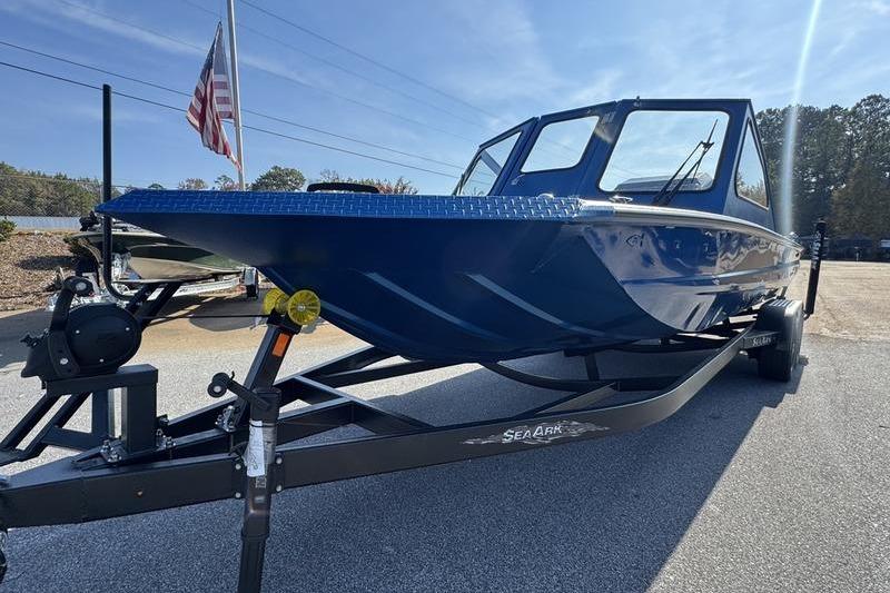 2026 SeaArk Dynasty 2.0 boat on trailer, blue exterior, parked outdoors.