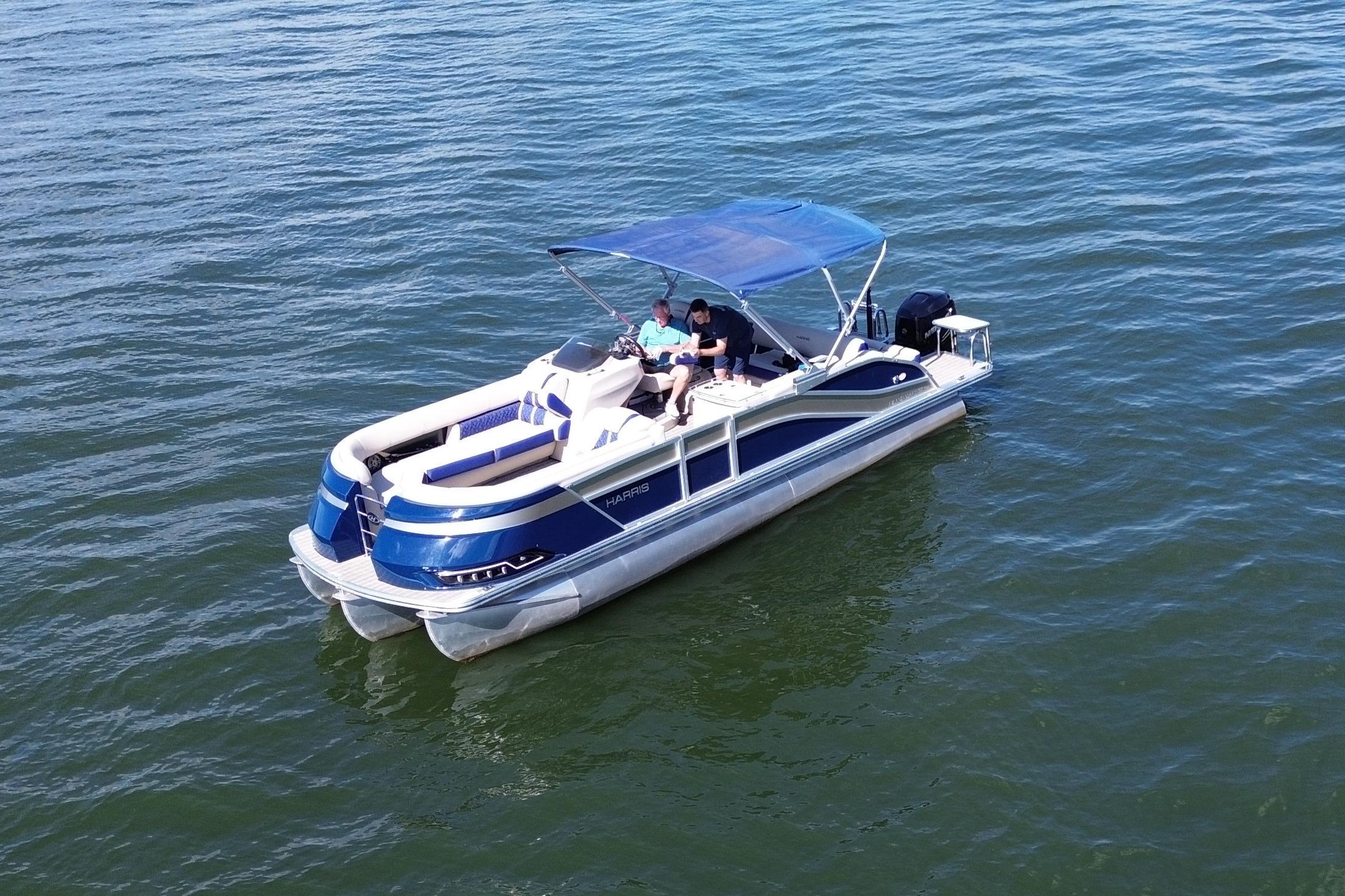 2022 Harris Grand Mariner 250 pontoon boat cruising on open water.