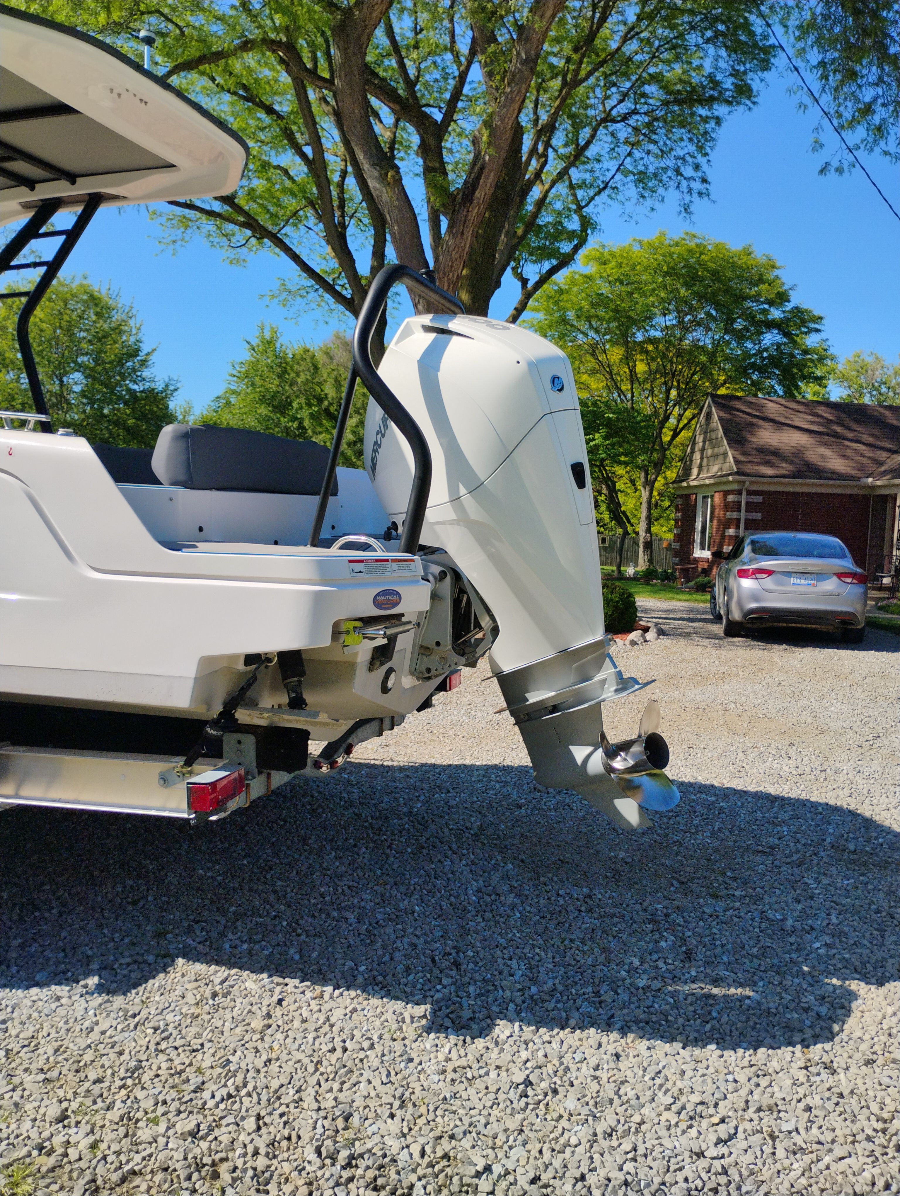 Axopar 22 T-Top 2022 with outboard motor parked outdoors.