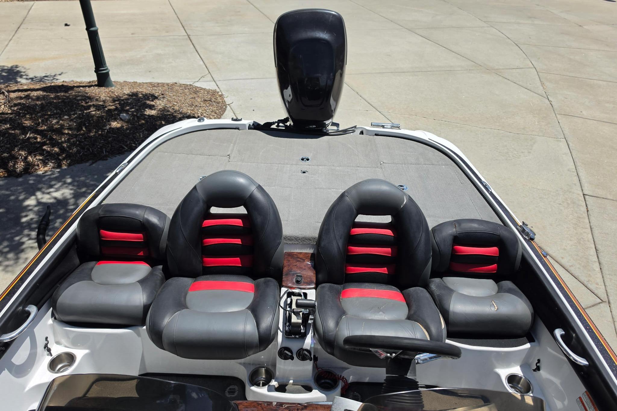 2008 Nitro Z-9 boat interior with black and red seating, steering wheel, and motor.