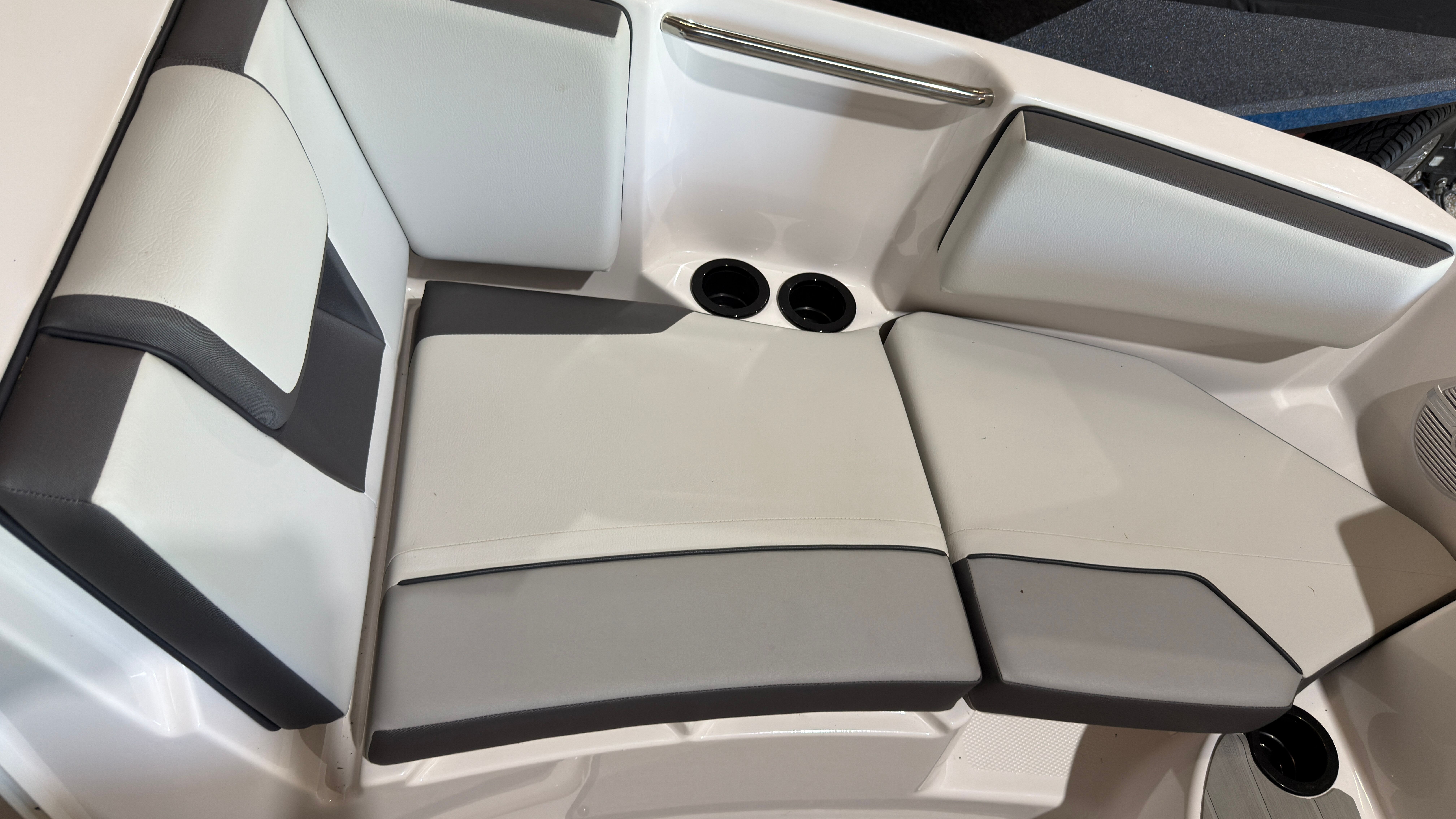 Interior of 2024 Yamaha AR220 boat with gray and white upholstery.
