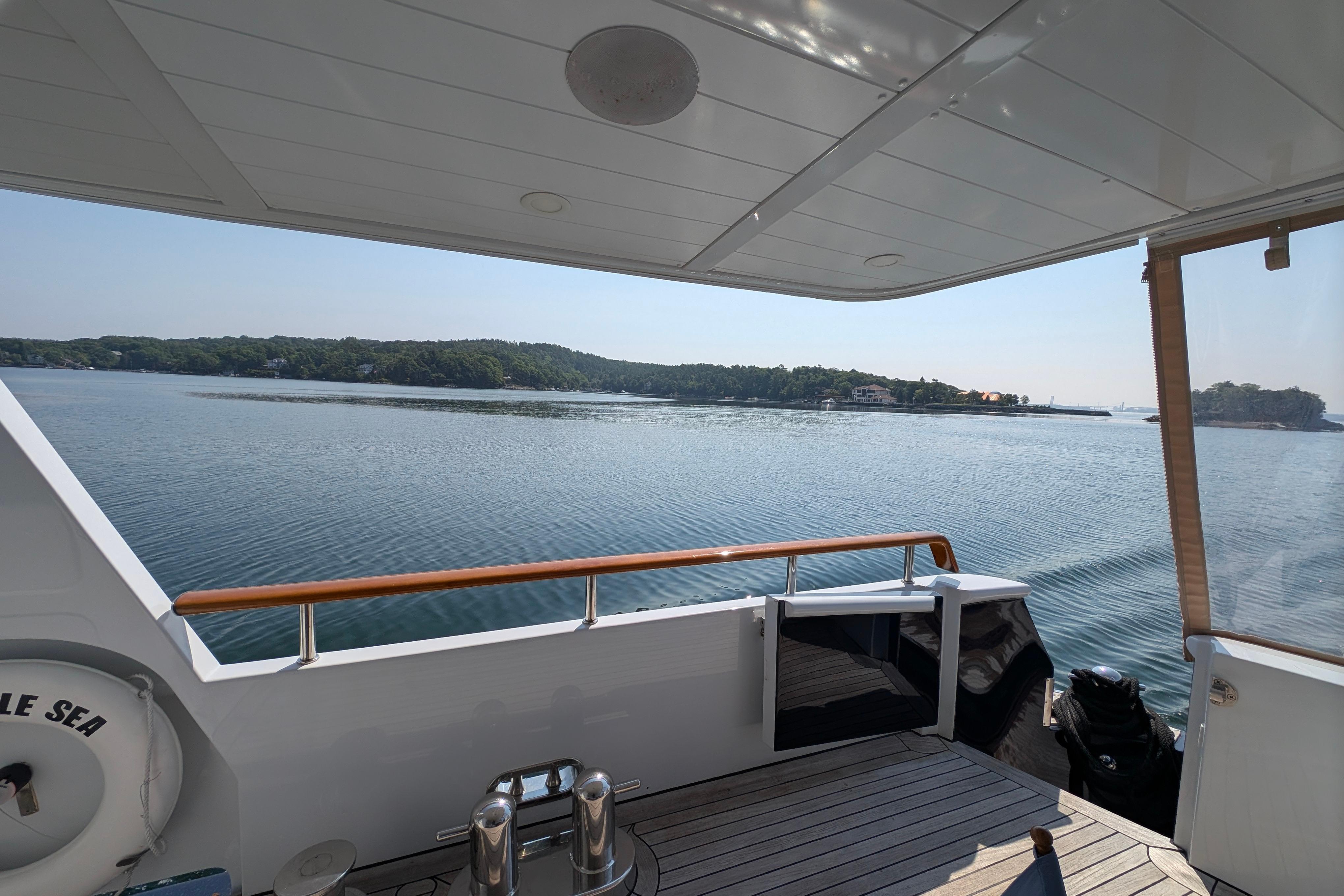 Luxurious 2001 Doggersbank yacht deck with serene waterfront view.