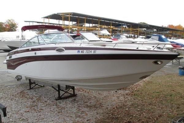 2004 Crownline 288 BR boat on display in a marina, surrounded by other vessels.