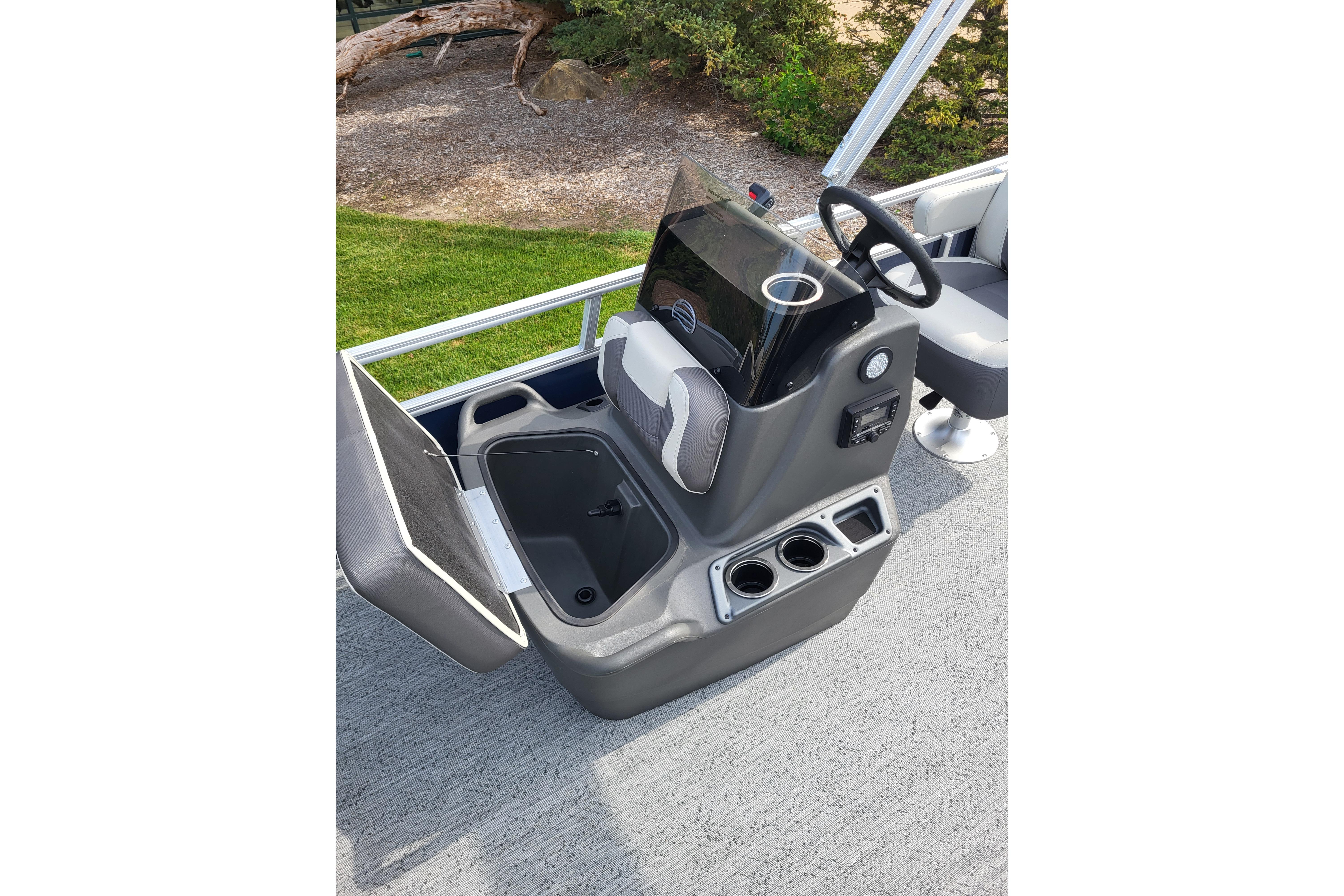 2026 Sun Tracker Bass Buggy 16 XL Select boat console with steering wheel and storage compartment.