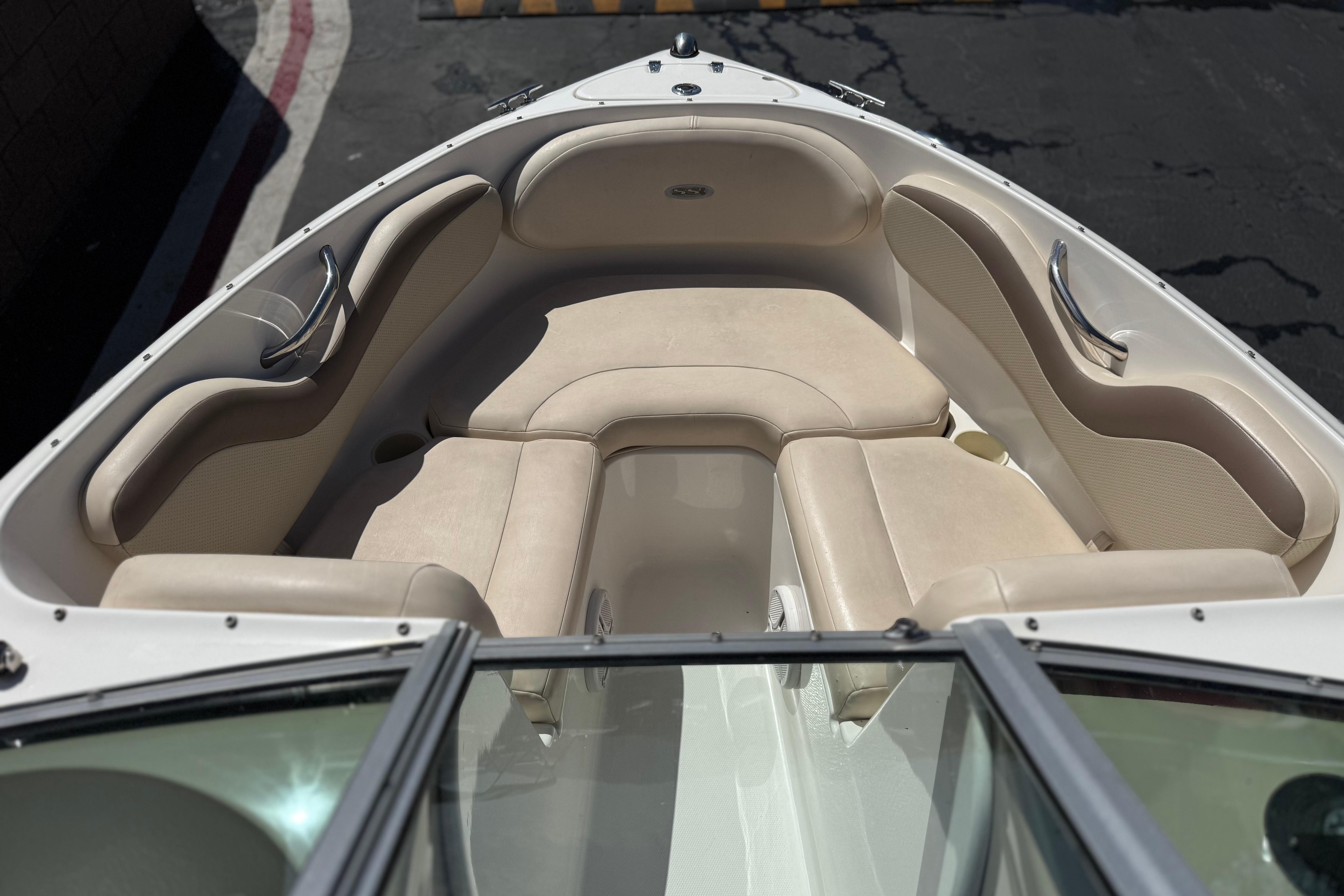 2006 Chaparral 190 SSi boat interior with beige seating and stainless steel handles.